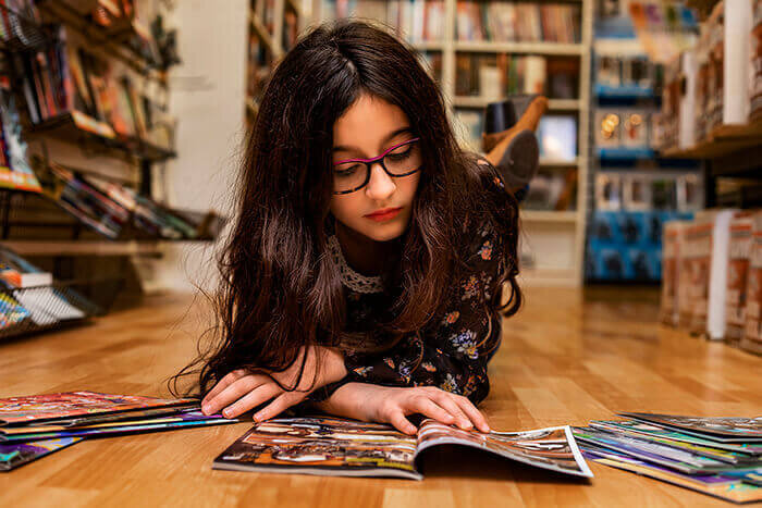girl-reads-comic-on-comic-book-store-floor