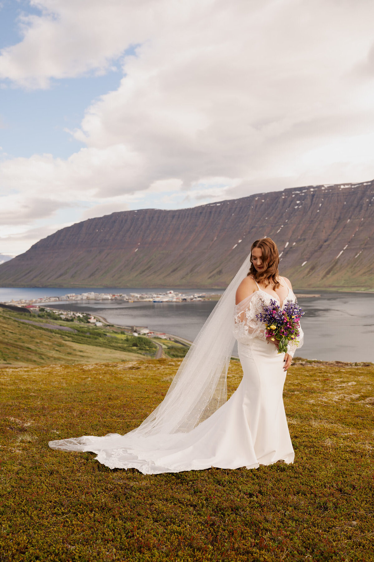 A bridal portrait in the Westfjords of Iceland overlooking the town of Ísafjörður.
