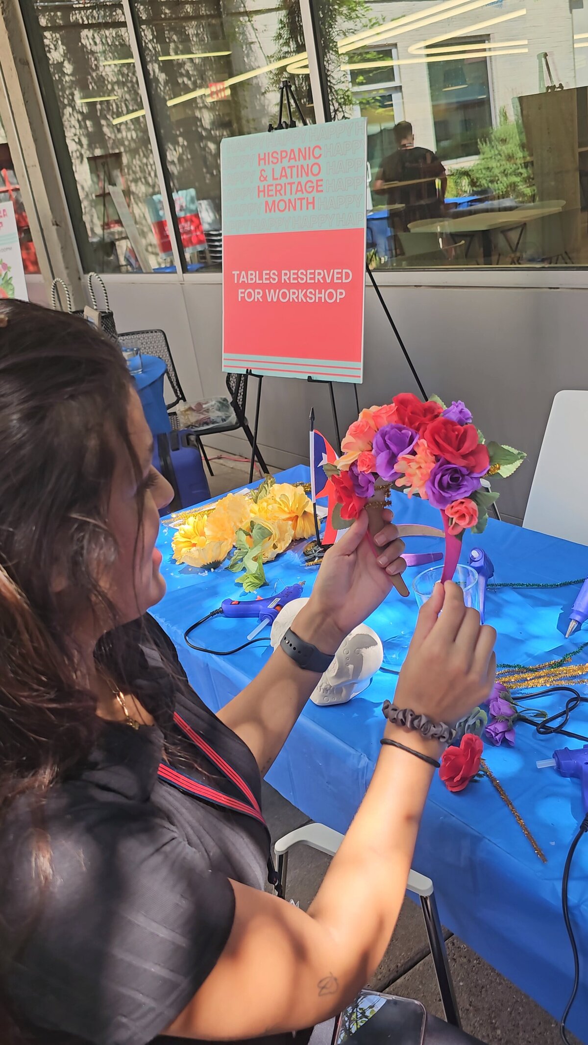The abundant array of materials on our workshop table with a blue tablecloth, showcasing everything needed to create stunning flower wreaths.