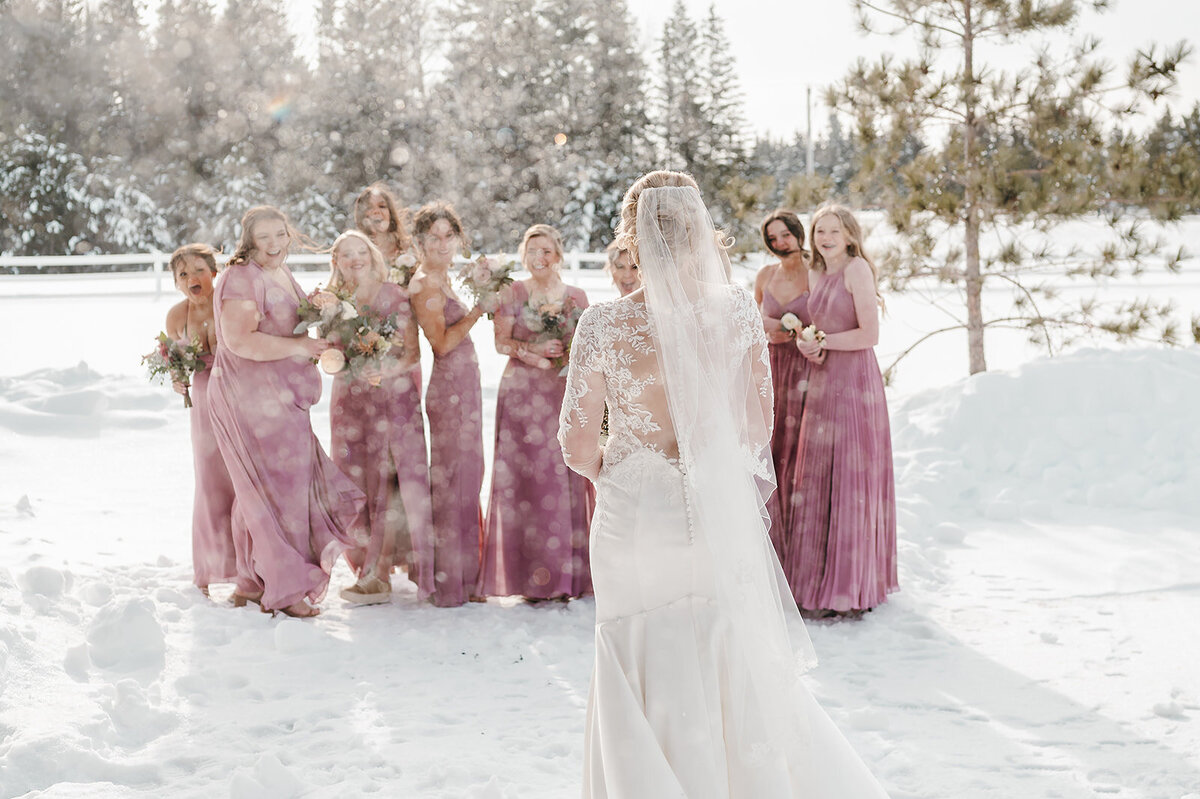 Bridesmaid first look with bride during winter wedding at the Bluebelle Event Venue