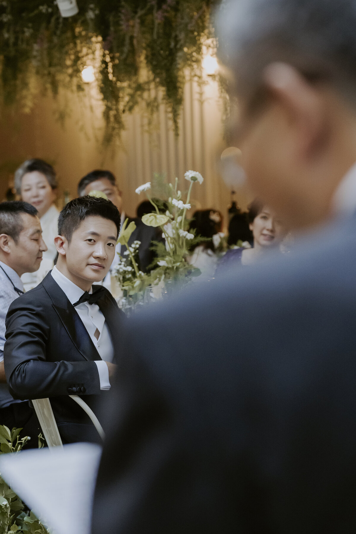the groom staring and listening to his father's speech