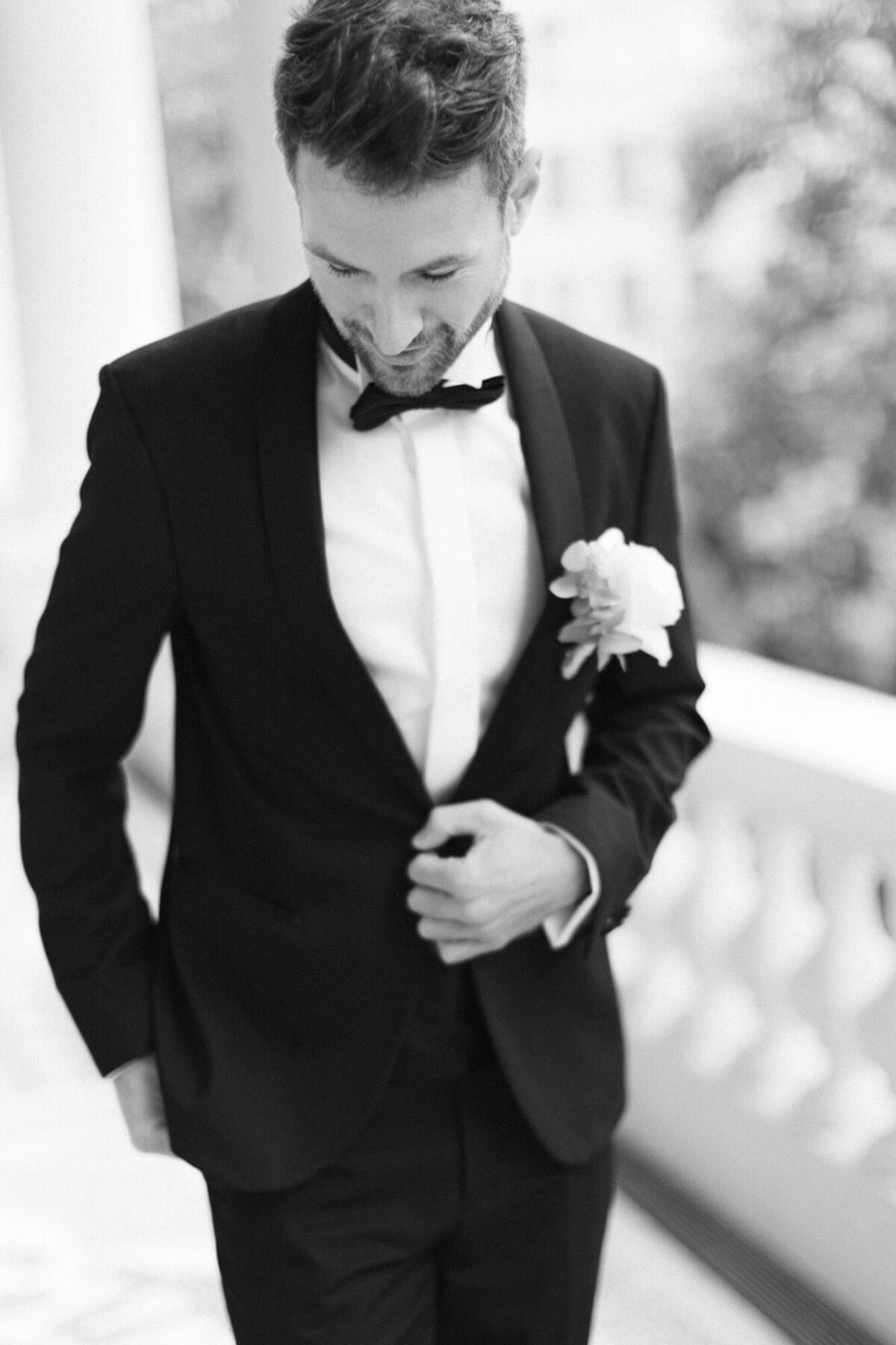 Groom walking on the terrace of palace Coburg looking on the floor minutes before the wedding ceremony 