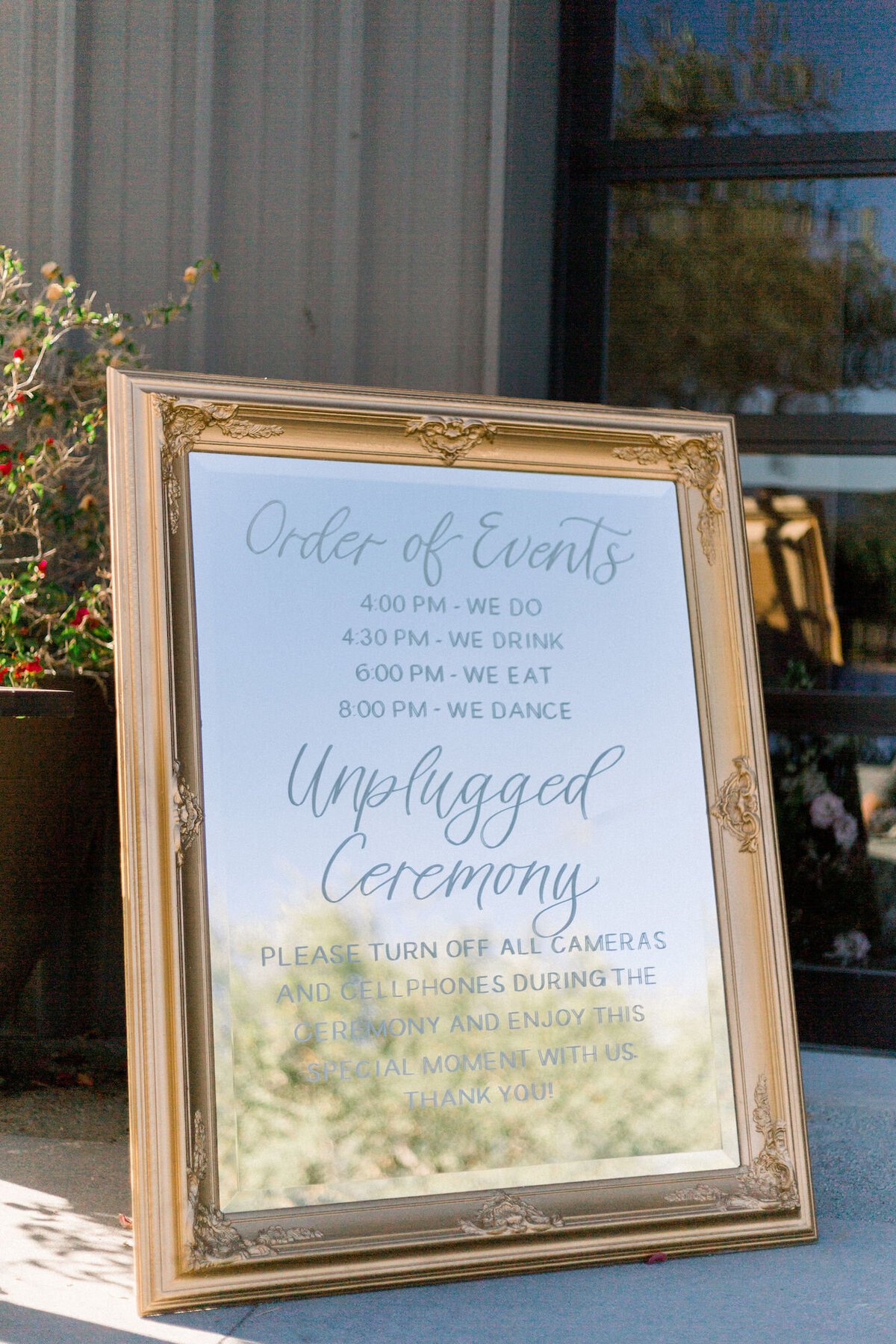 Unplugged sign in handwritten calligraphy on gold framed mirror