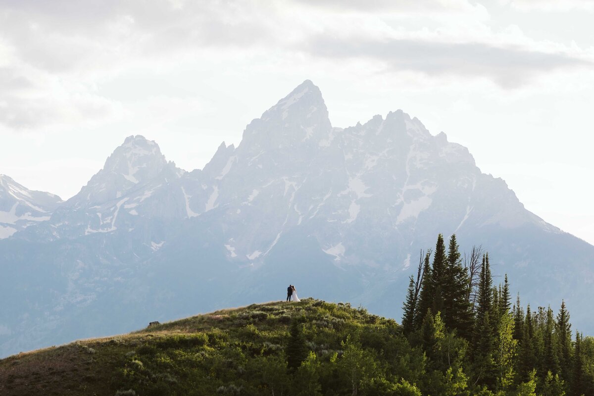 stunning wedding coupe standing in front of the Grand Teton