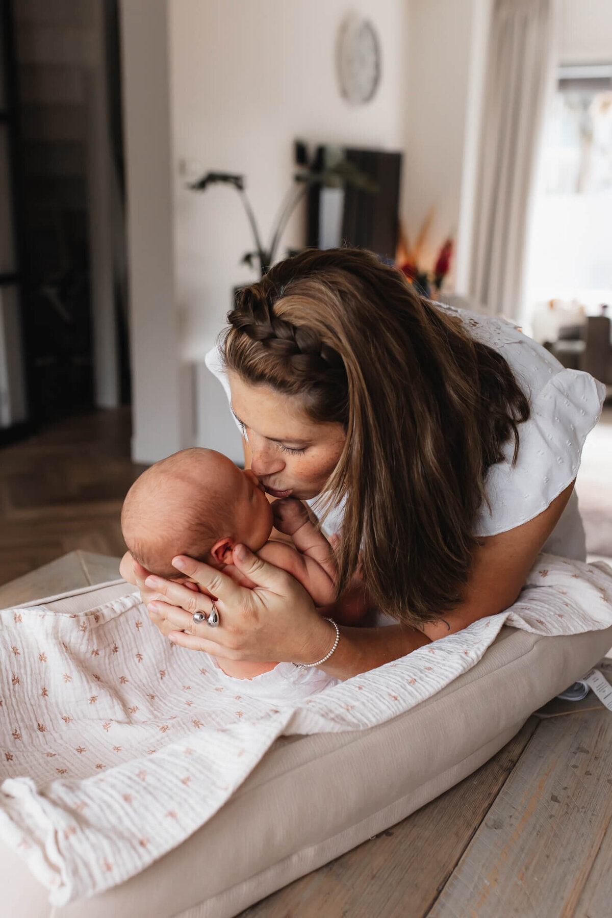 Kraamreportage mama verschoont de baby en geeft een kusje