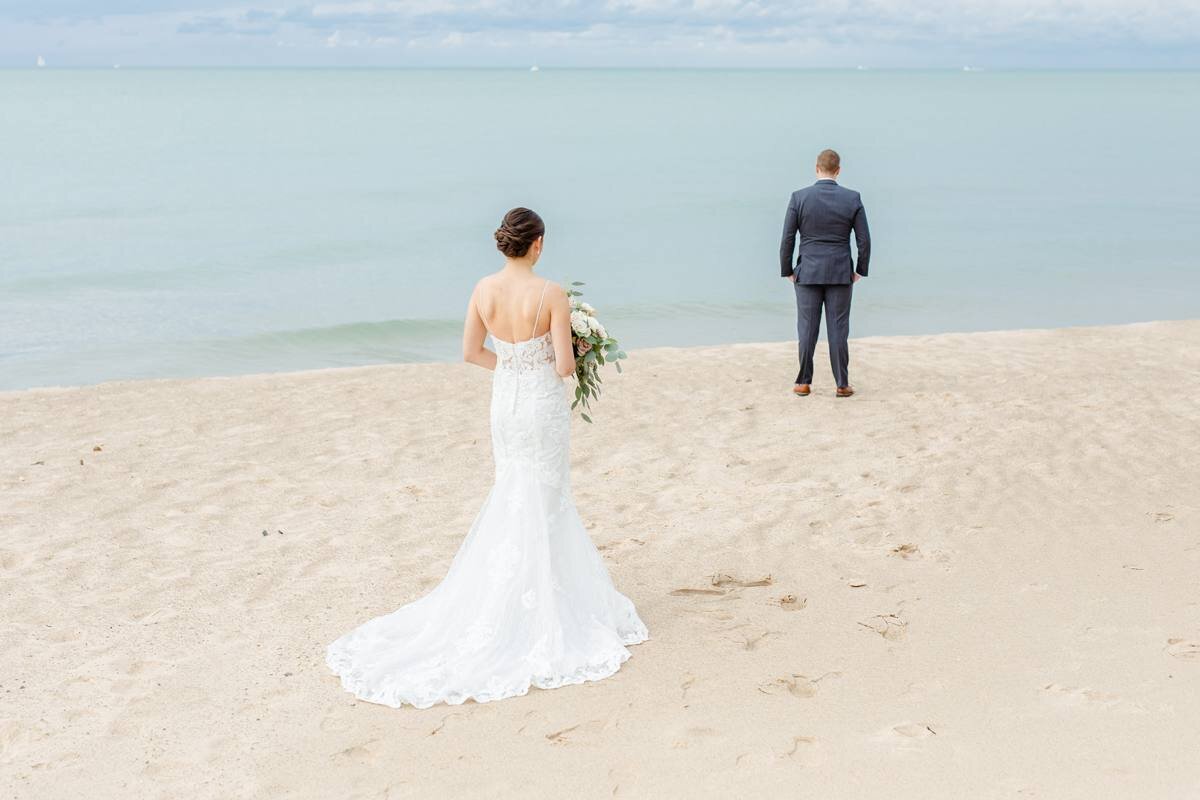 first look with couple on beach on lake michigan