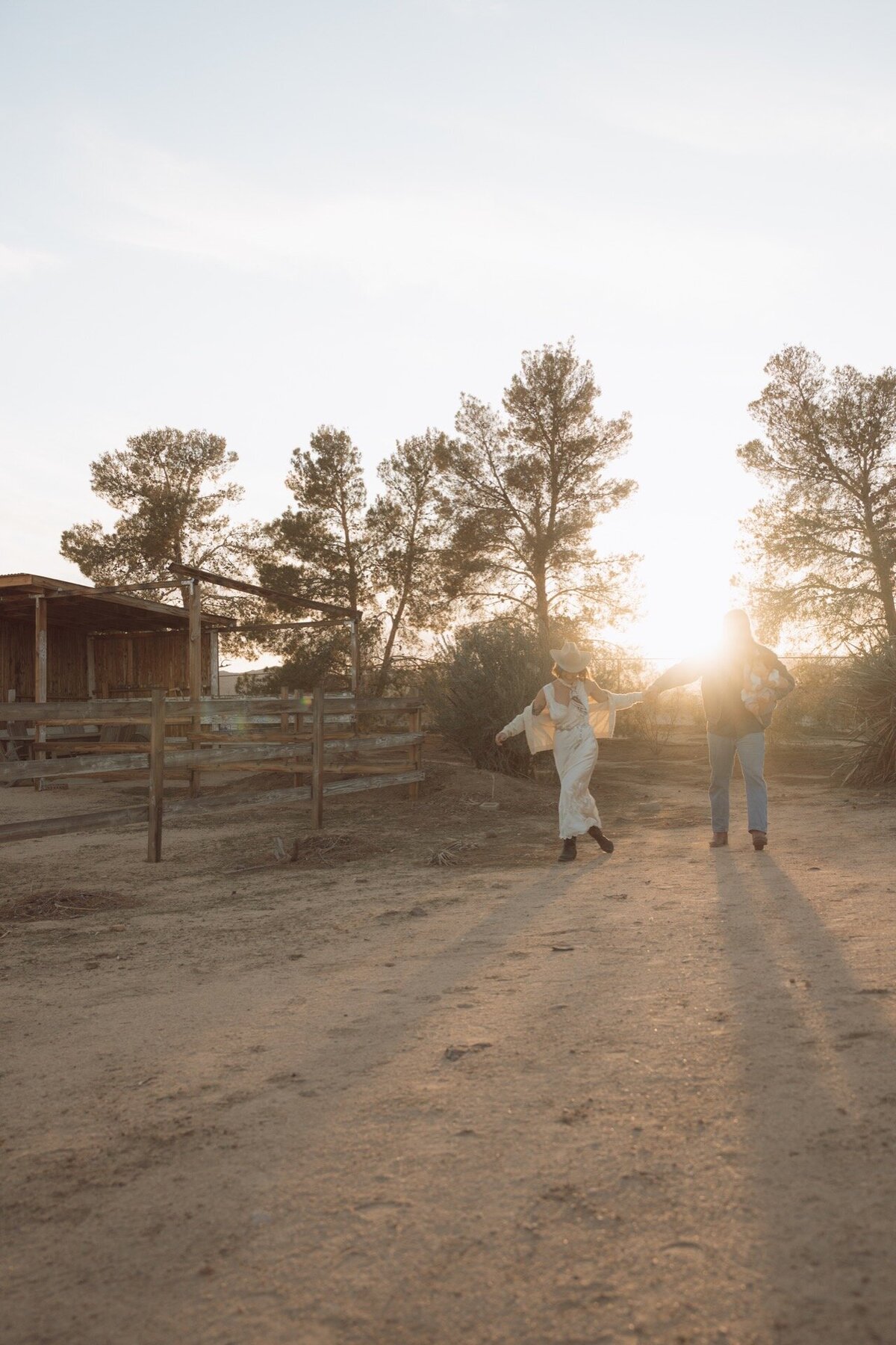family of three walking outdoors at yucca valley california ranch golden hour