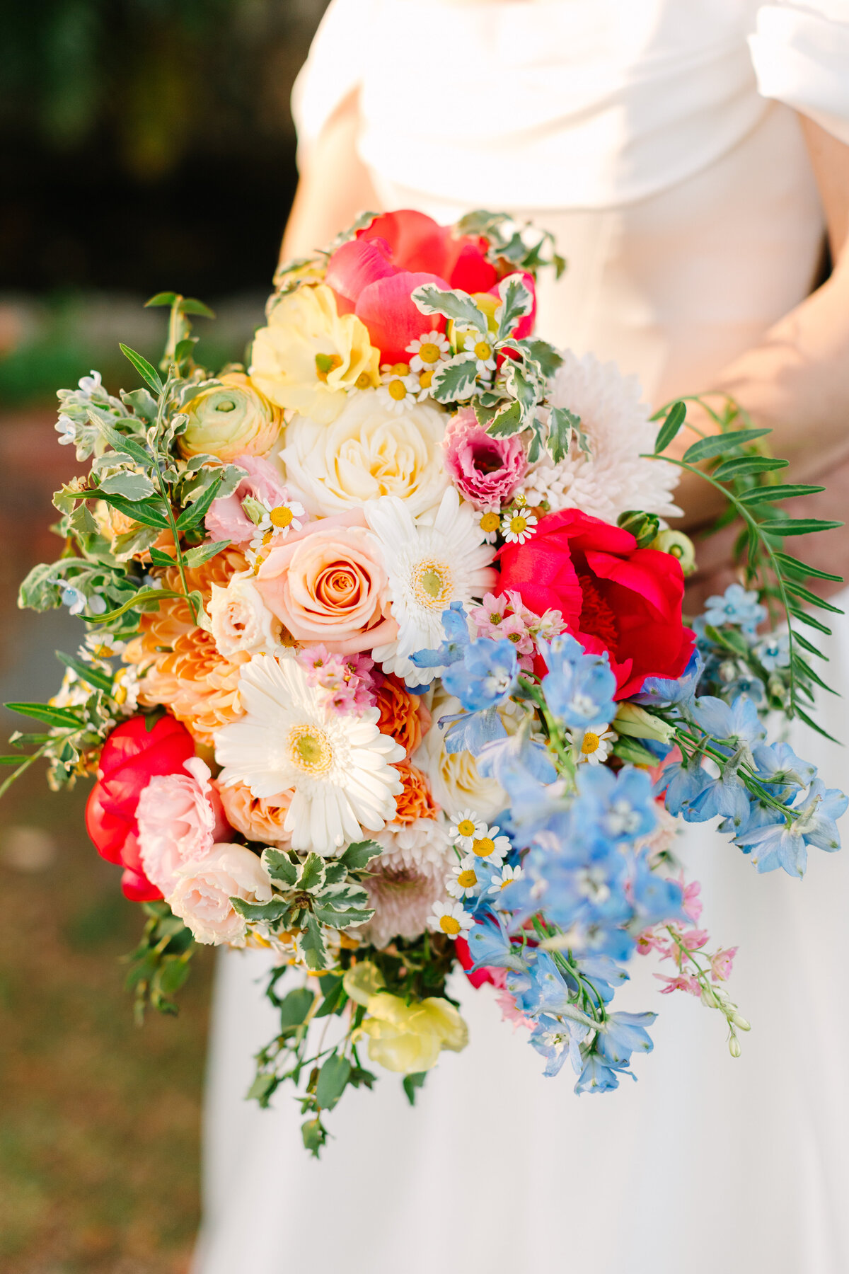 Hermitage Norfolk Wedding Photographer capturing bride holding her bouquet from Virginia Beach Florist