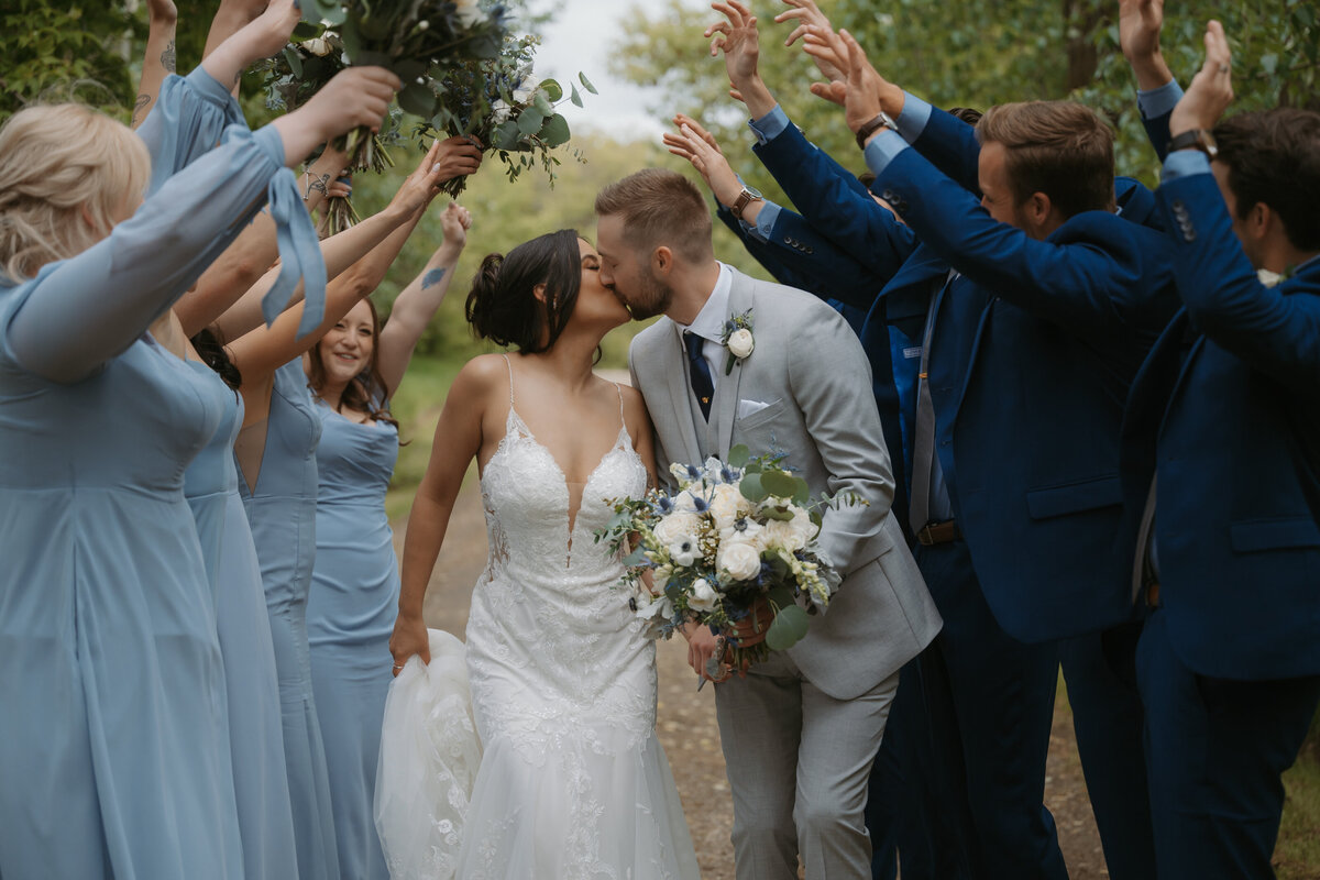 couple running through bridal party on wedding day