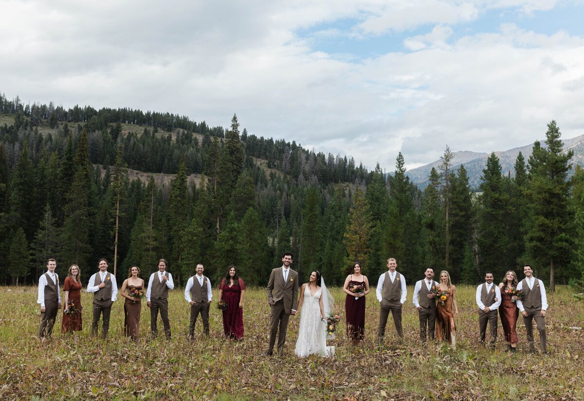 wedding party standing in field at outdoor idaho wedding in nature