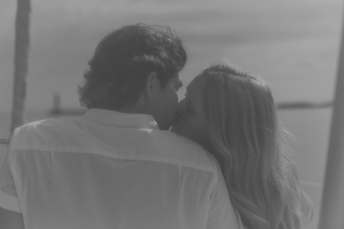 Back View of couple kissing on a boat in WIsconsin