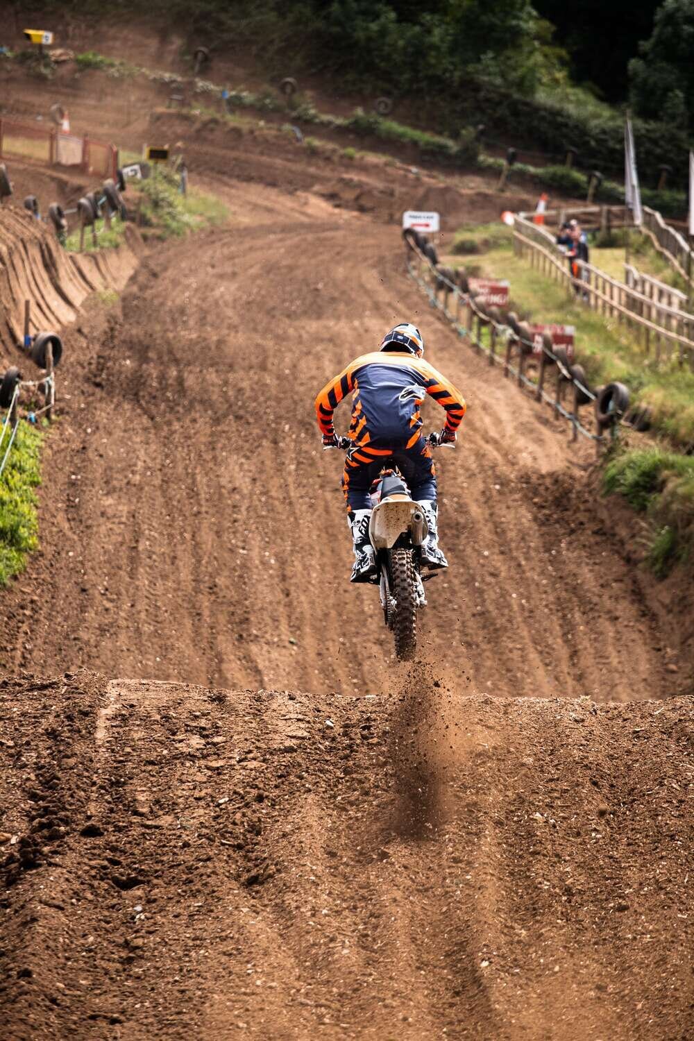 Motorcross rider in mid air over track