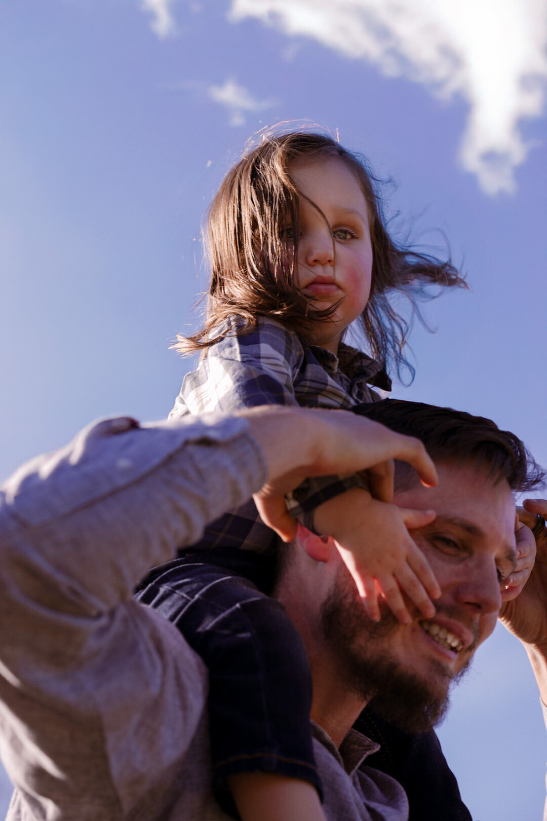 family outdoor photography looking up at blue sky