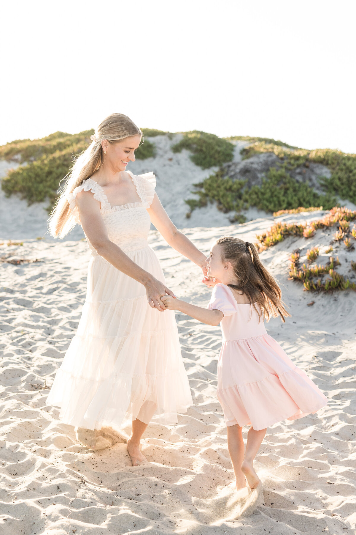 mother-and-daughter-twirling-in-coronado-sand-dunes