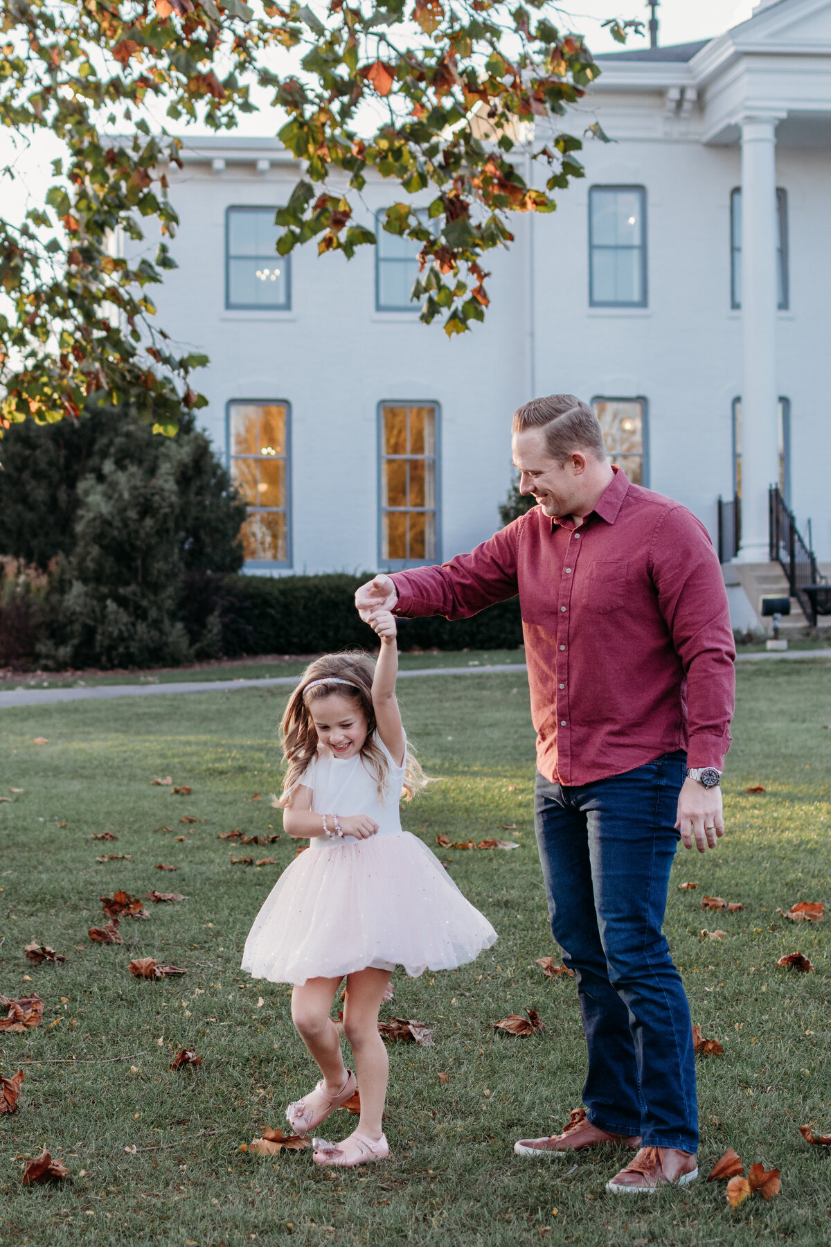 dad dancing with daughter during a family photoshoot in Elmhurst, Il