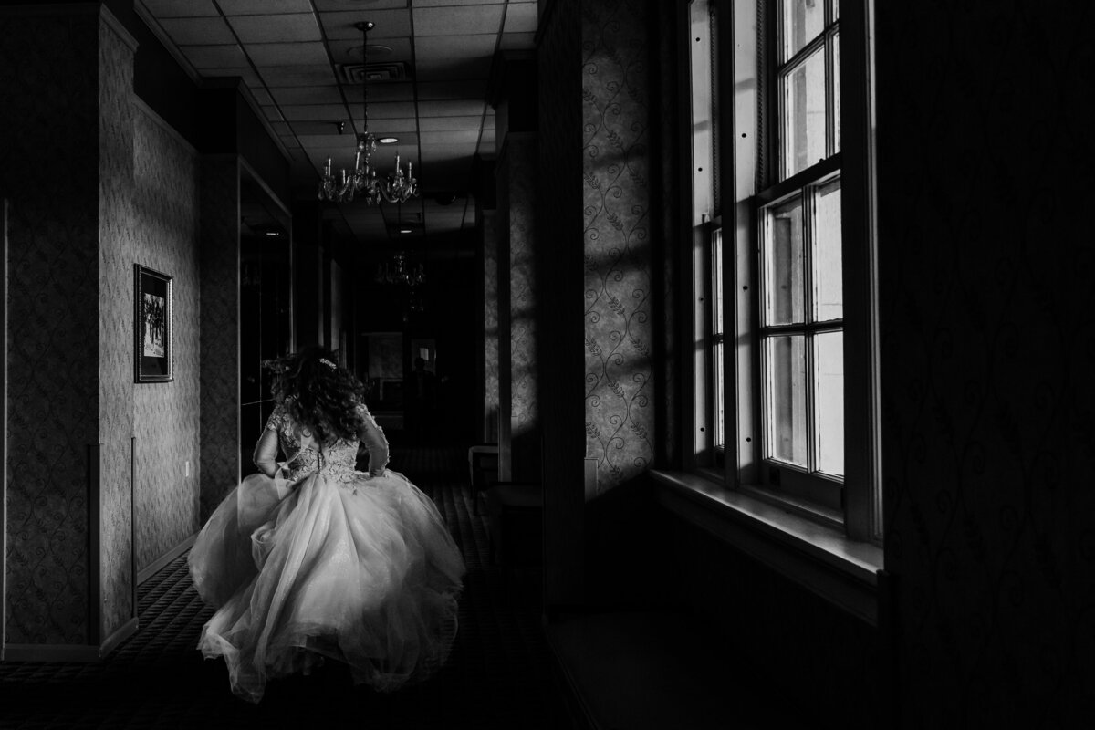 Bride runs down hallway