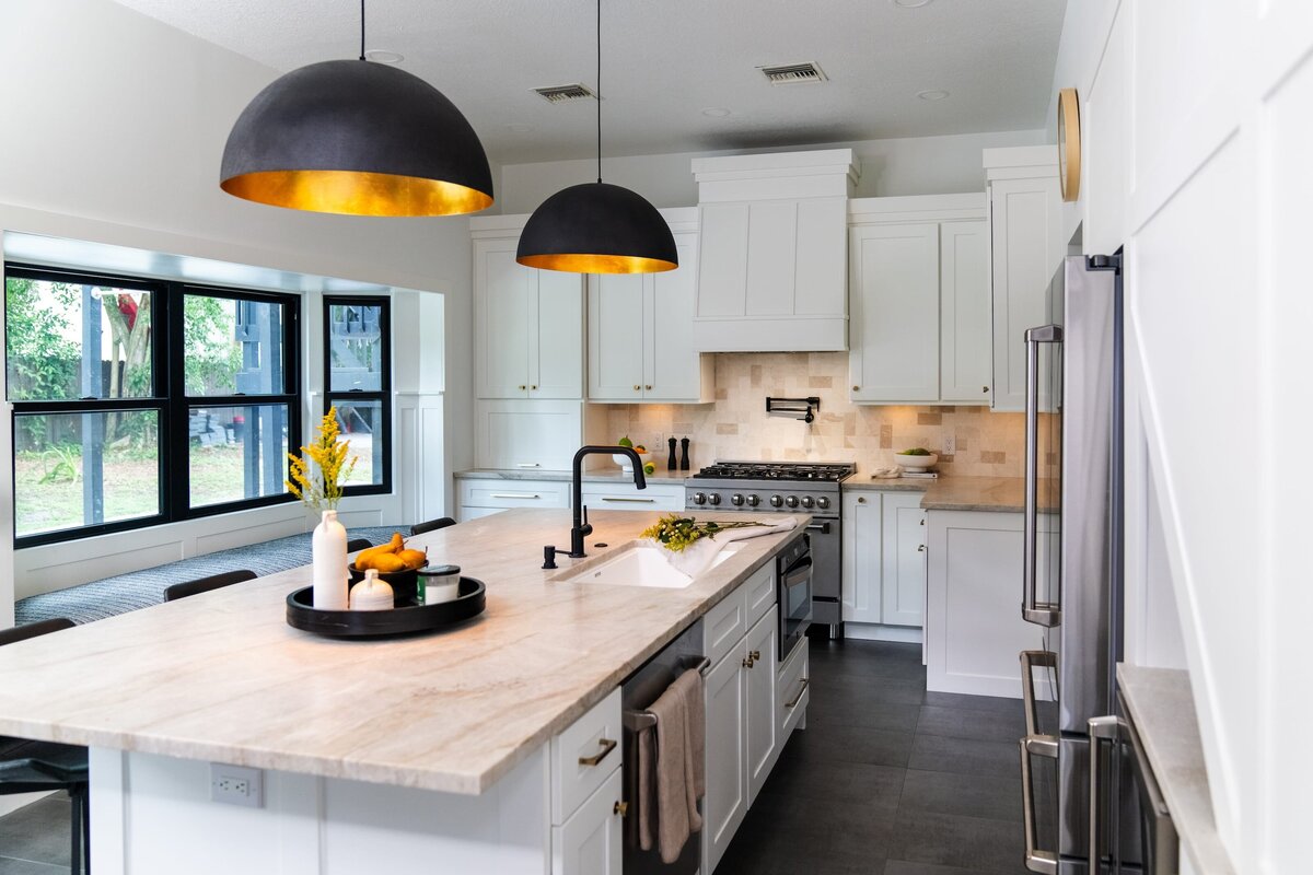 dewine design interiors farmhouse modern kitchen with black hangin pendents over large island