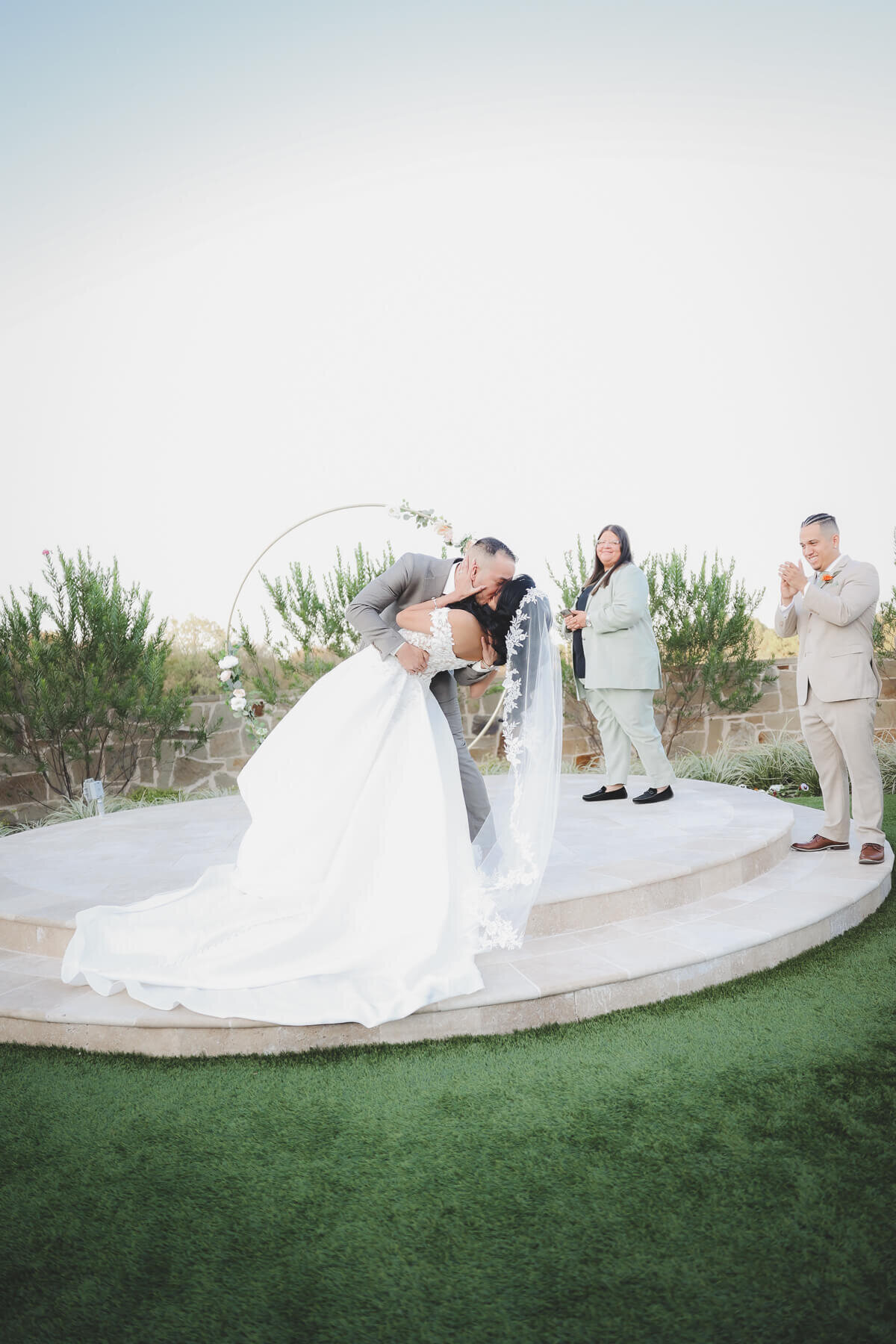 A bride and groom kiss after their ceremony.