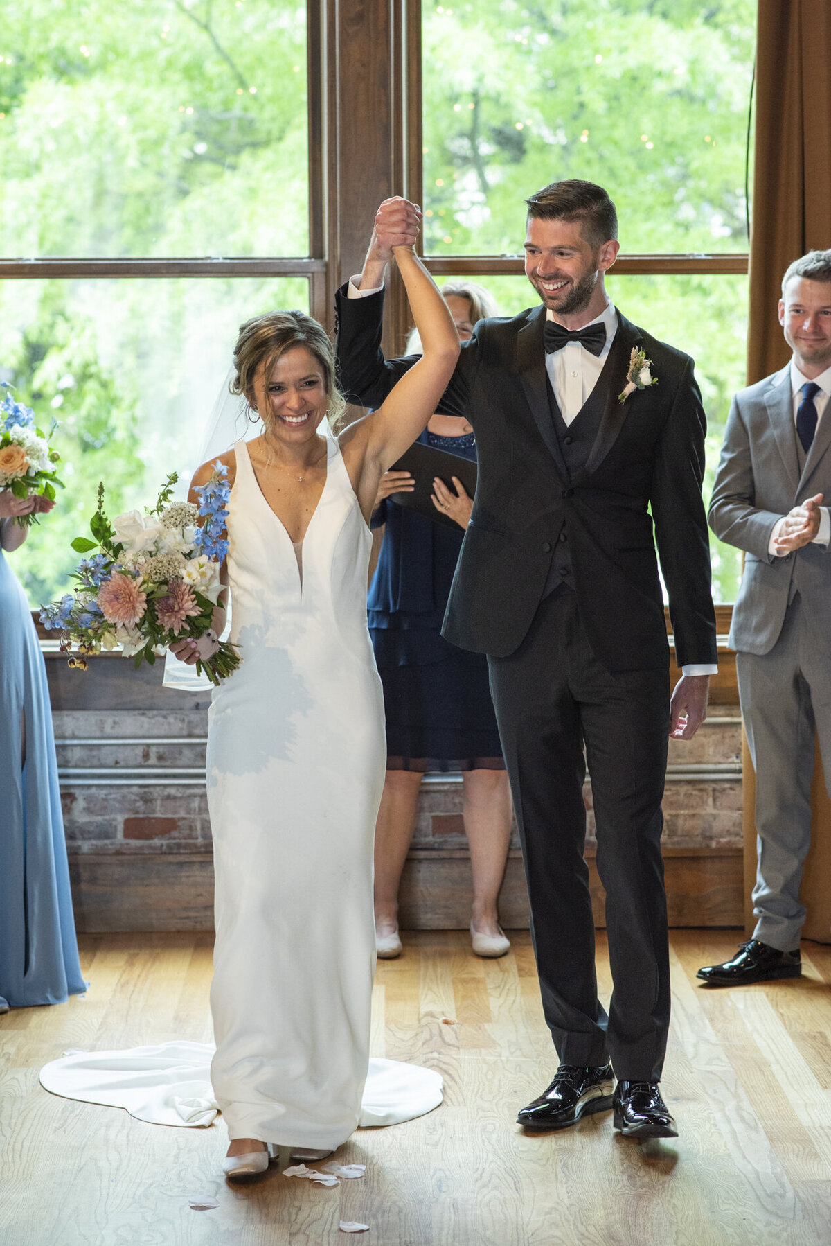 Couple recessing at wedding at Century Room on the Park Asheville