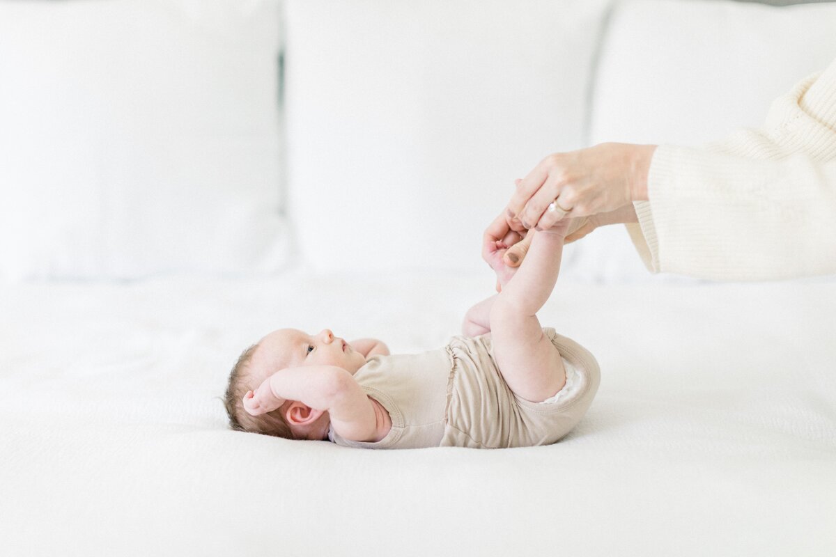 tickling newborn feet by Orlando in-home newborn photographer