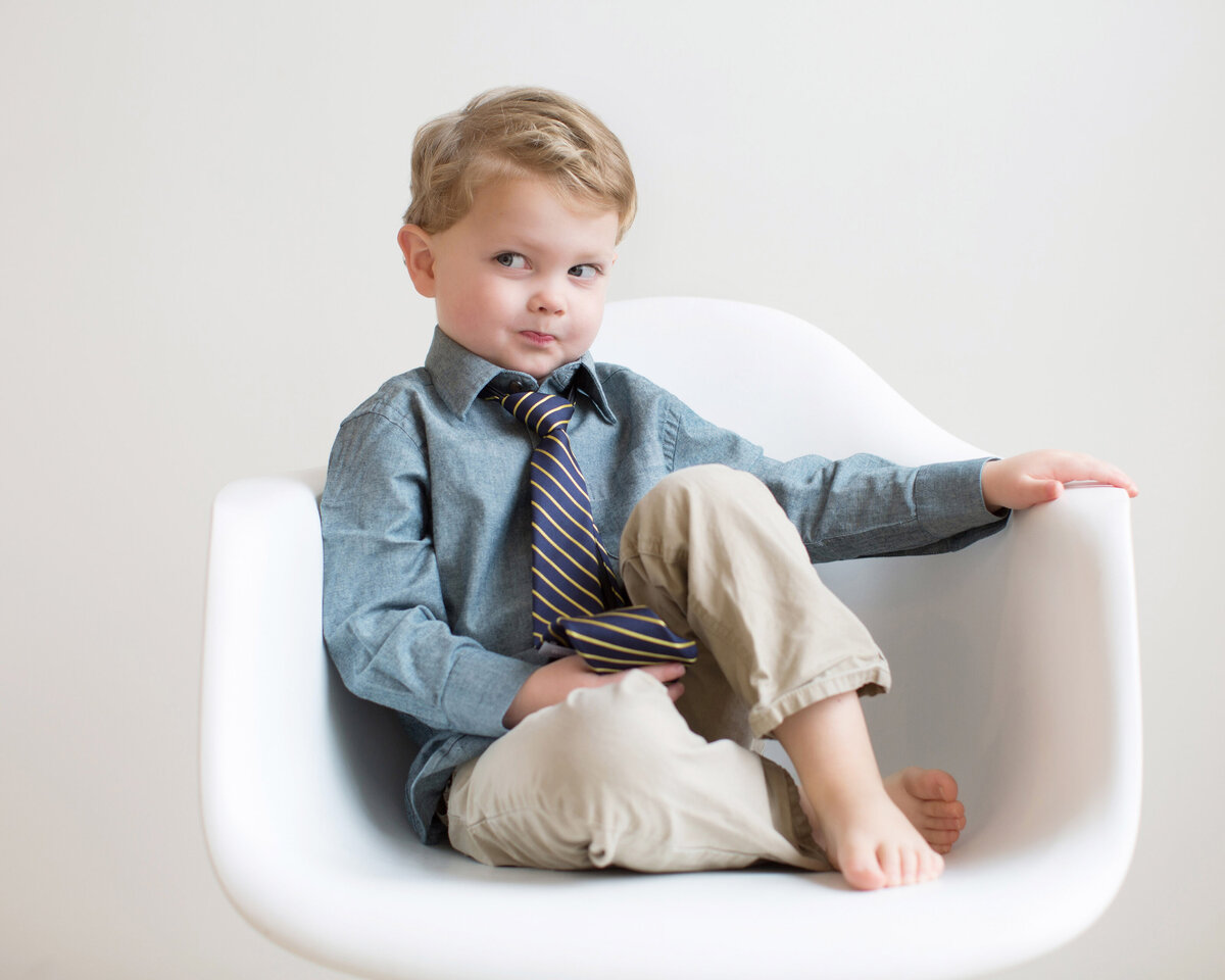 boy-in-eames-chair-making-silly-face