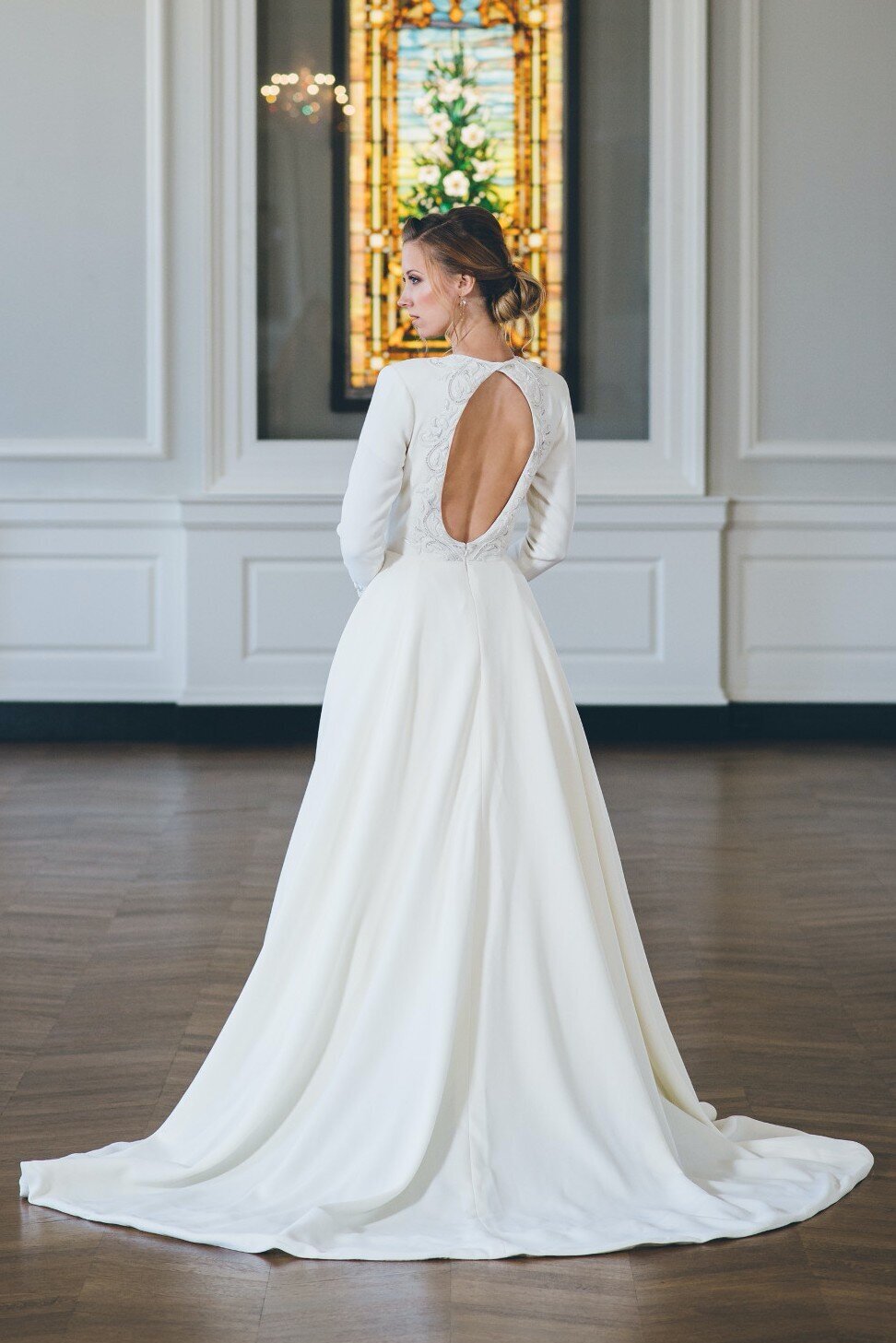 This long sleeve ballgown wedding dress reveals a keyhole back detail in the bodice.