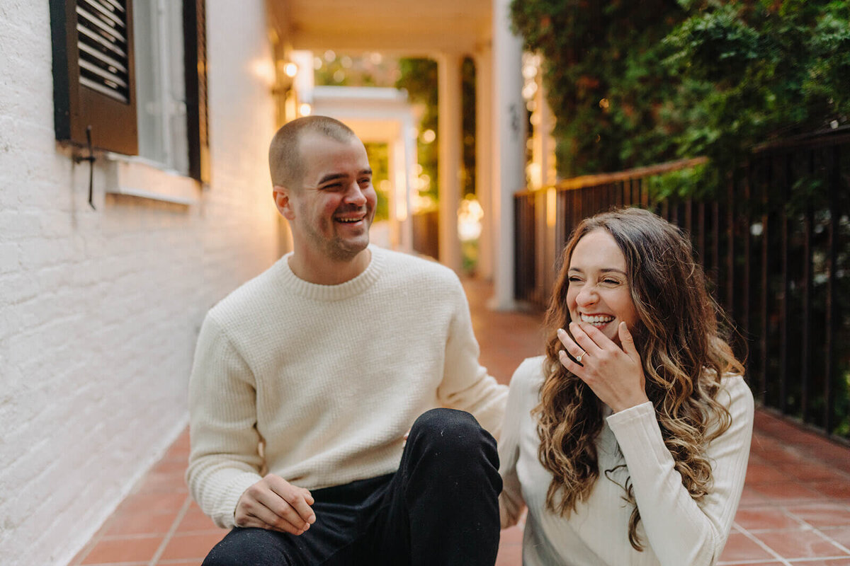 Couple sat on a porch at Finger Lakes engagement session
