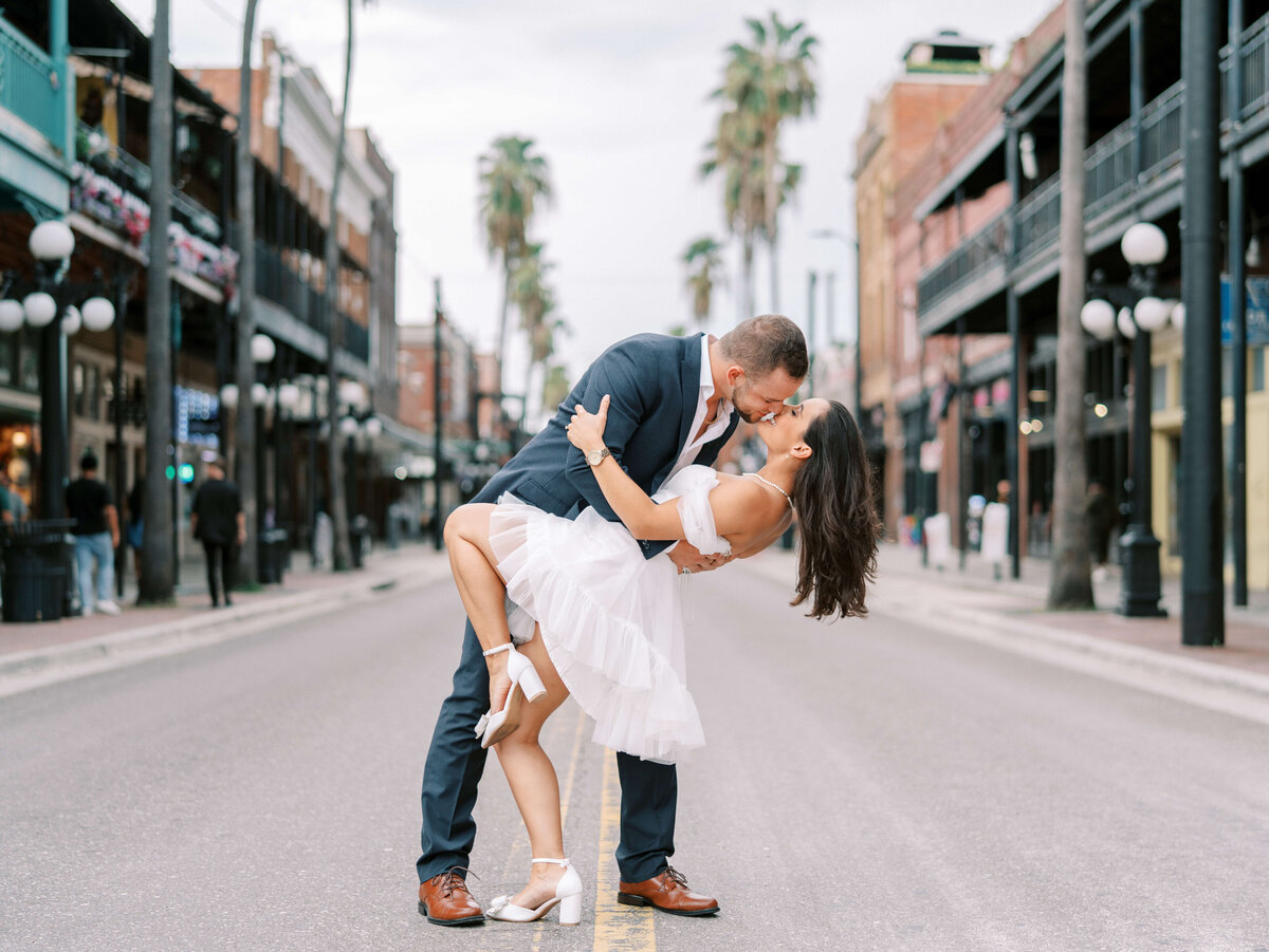 A couple dipping and kissing on a cobblestone street in Ybor City