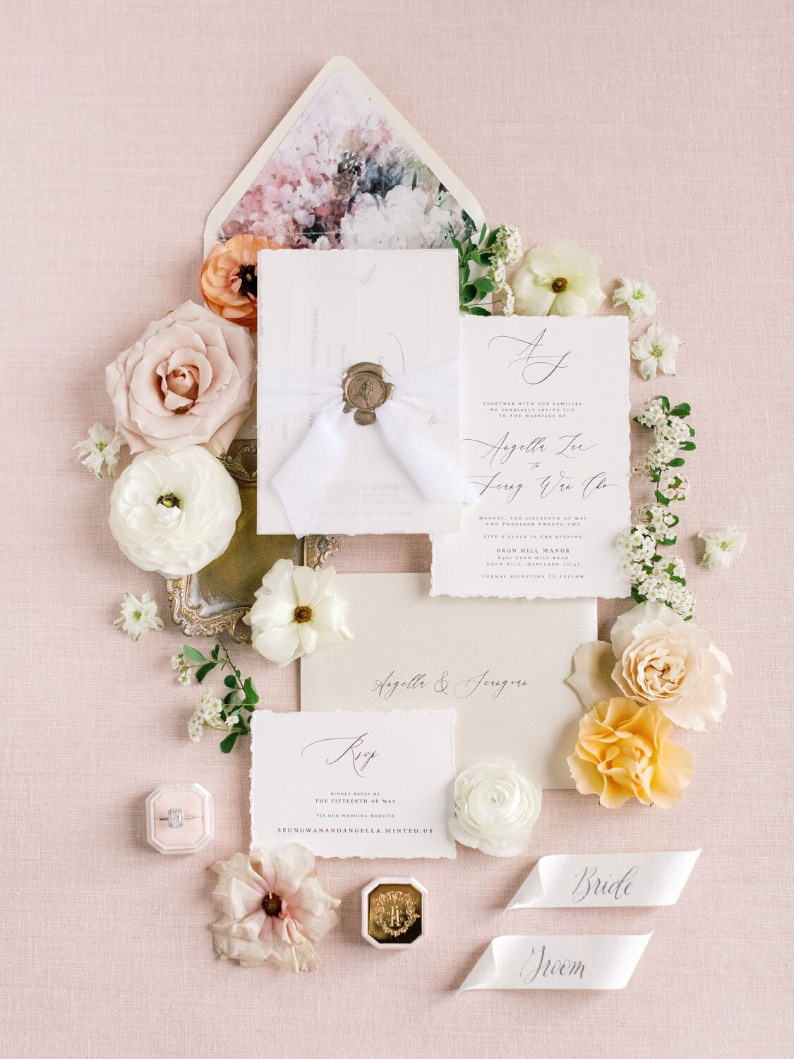 Flat lay of wedding invitations with flowers
