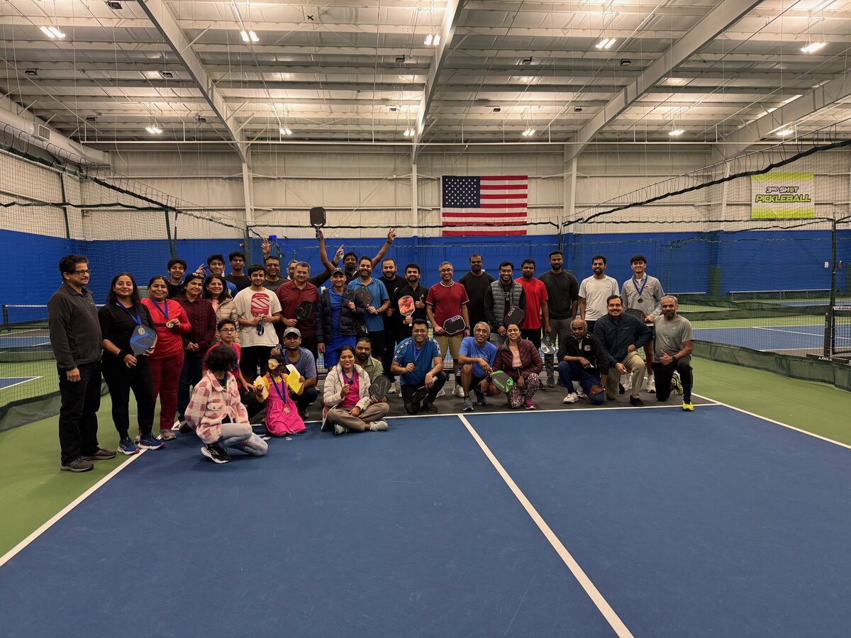 Event guests gathered together for a fun group photo on the pickleball courts, showcasing the energy and camaraderie of private events at the club.