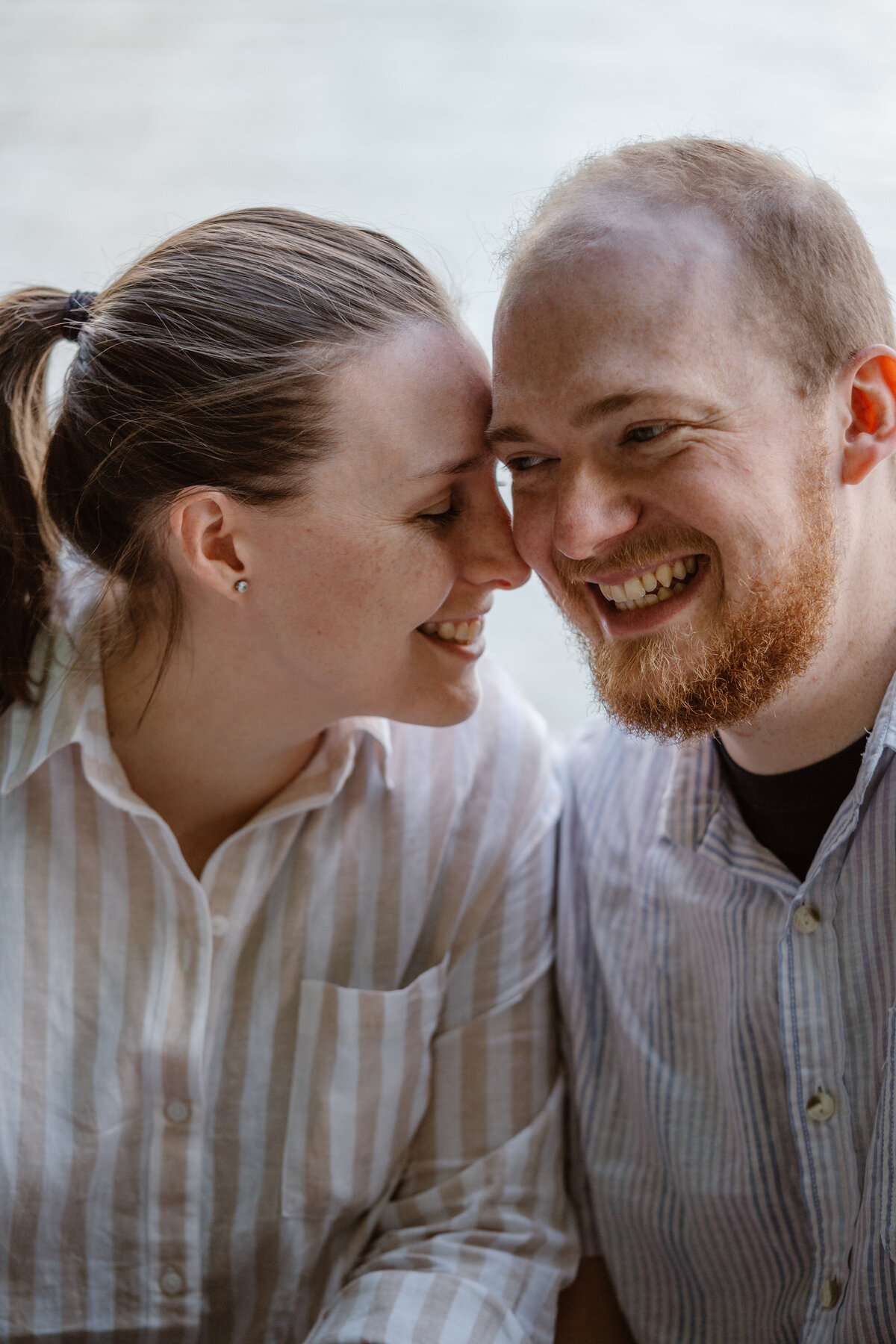 A couple with their heads close laughing together