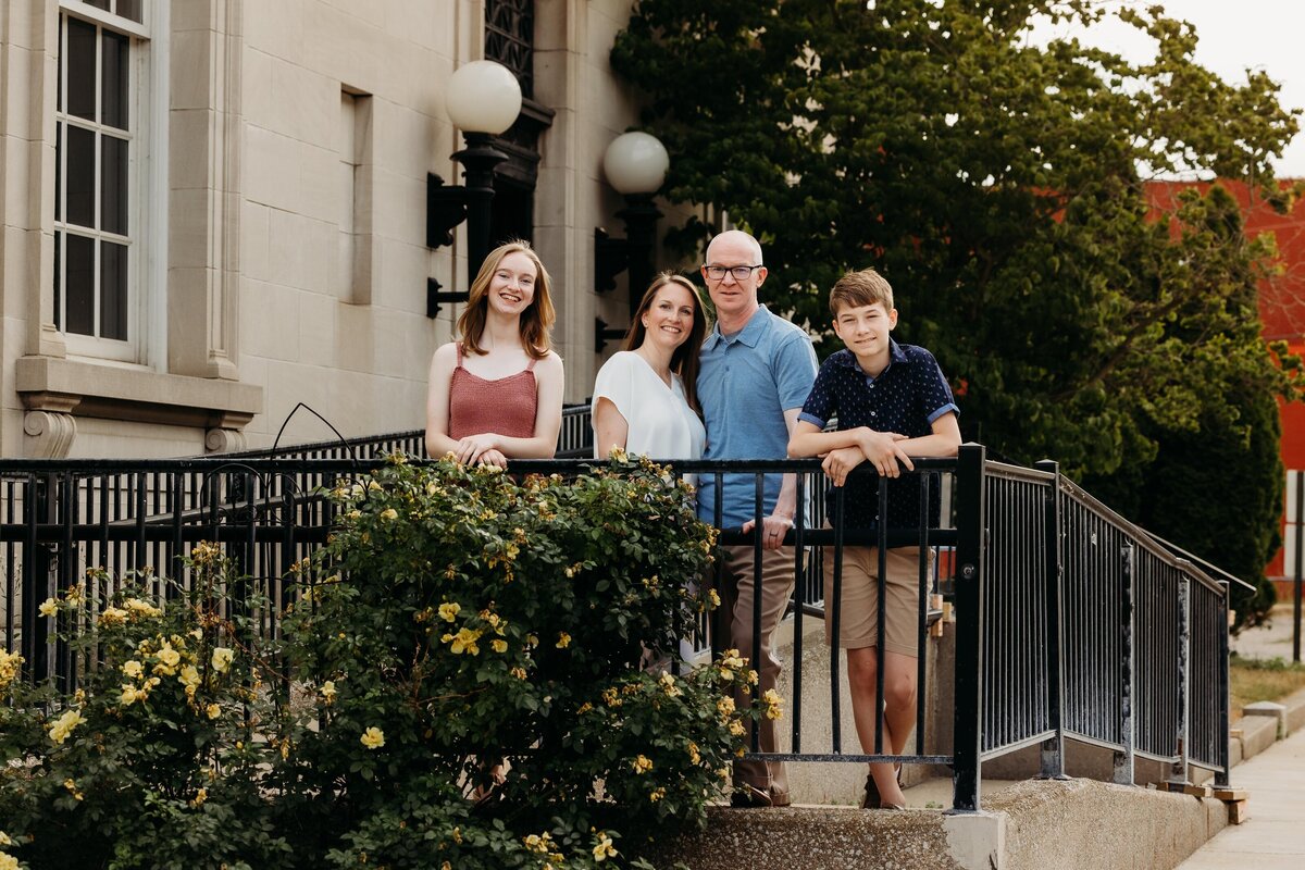 Family leaning on fence outside of Ionia Post Office.