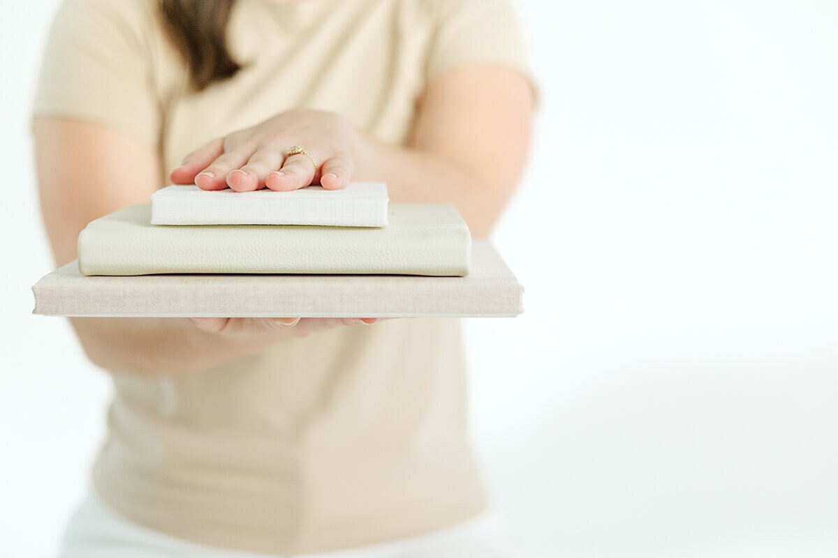 photographer holding albums