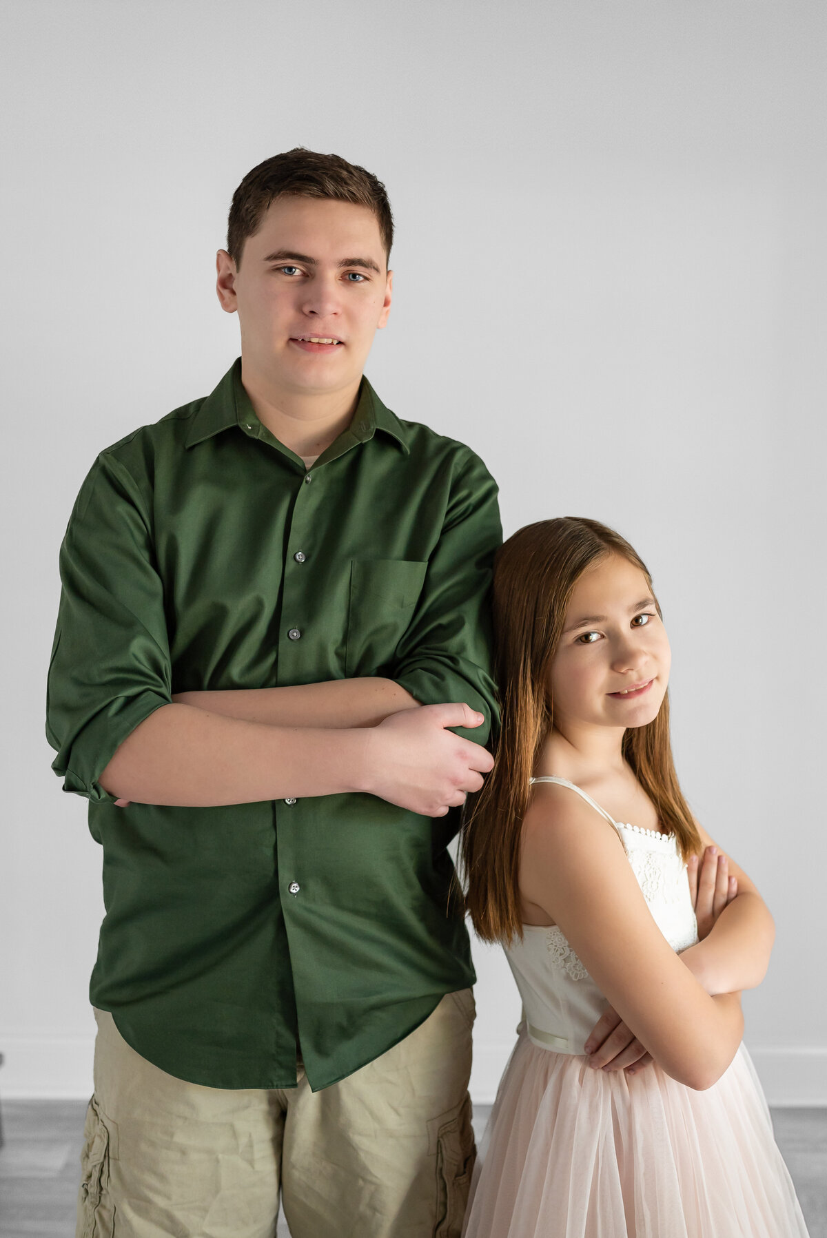 A brother and sister pose together for family pictures in Huntsville Alabama