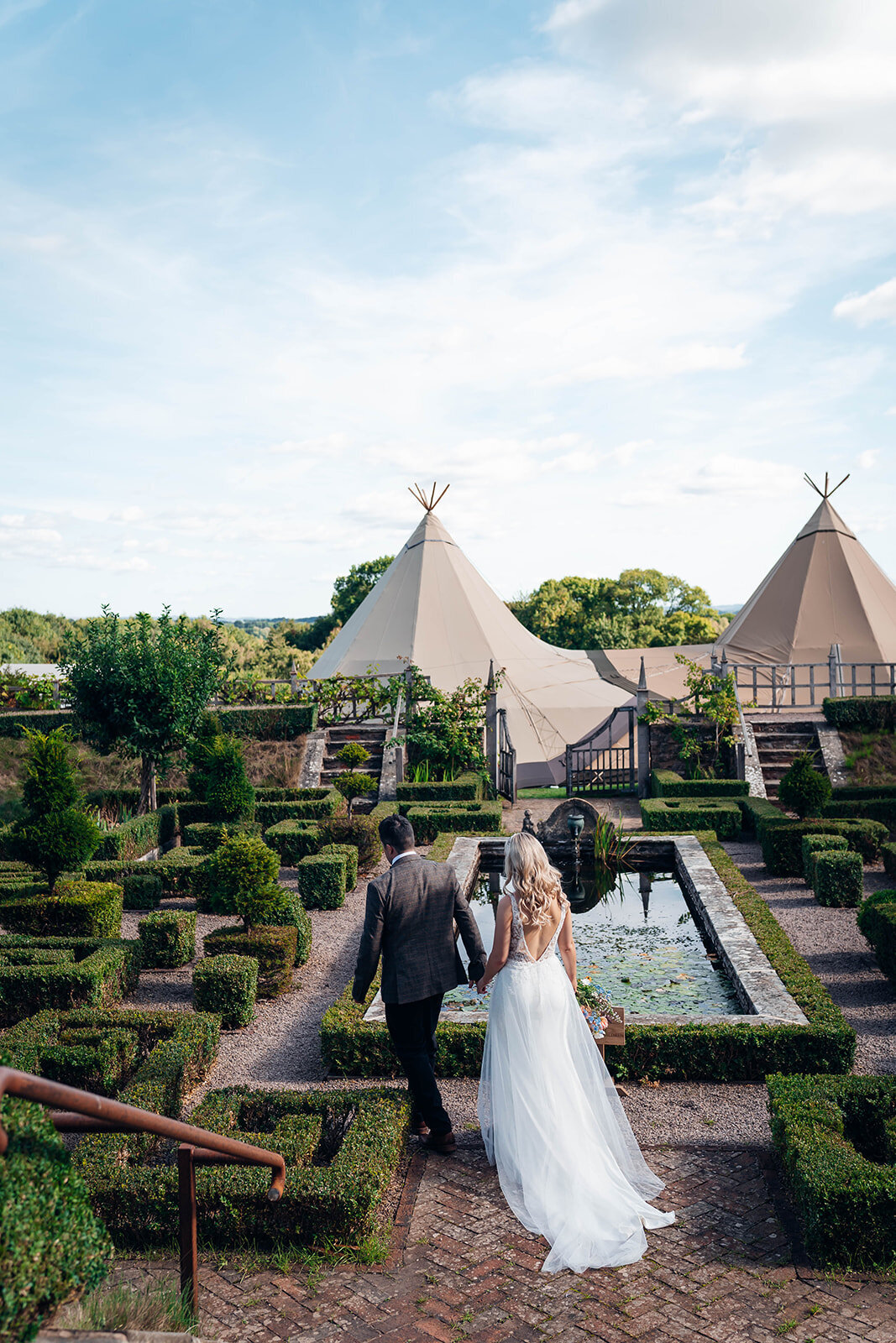 cheltenham-wedding-photographer-couple-walking-through-pauntley-court-gardens