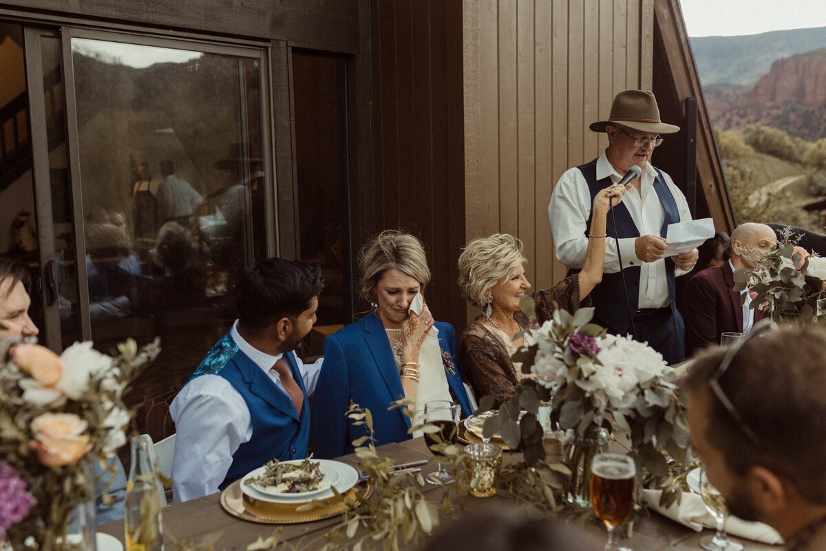 A bride crying as her dad makes a speech at her Intimate Wedding in Colorado