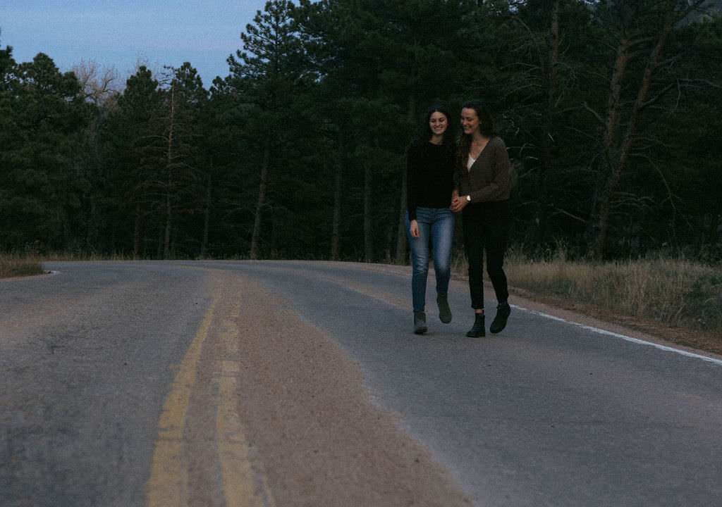 A couple walking along an empty street.