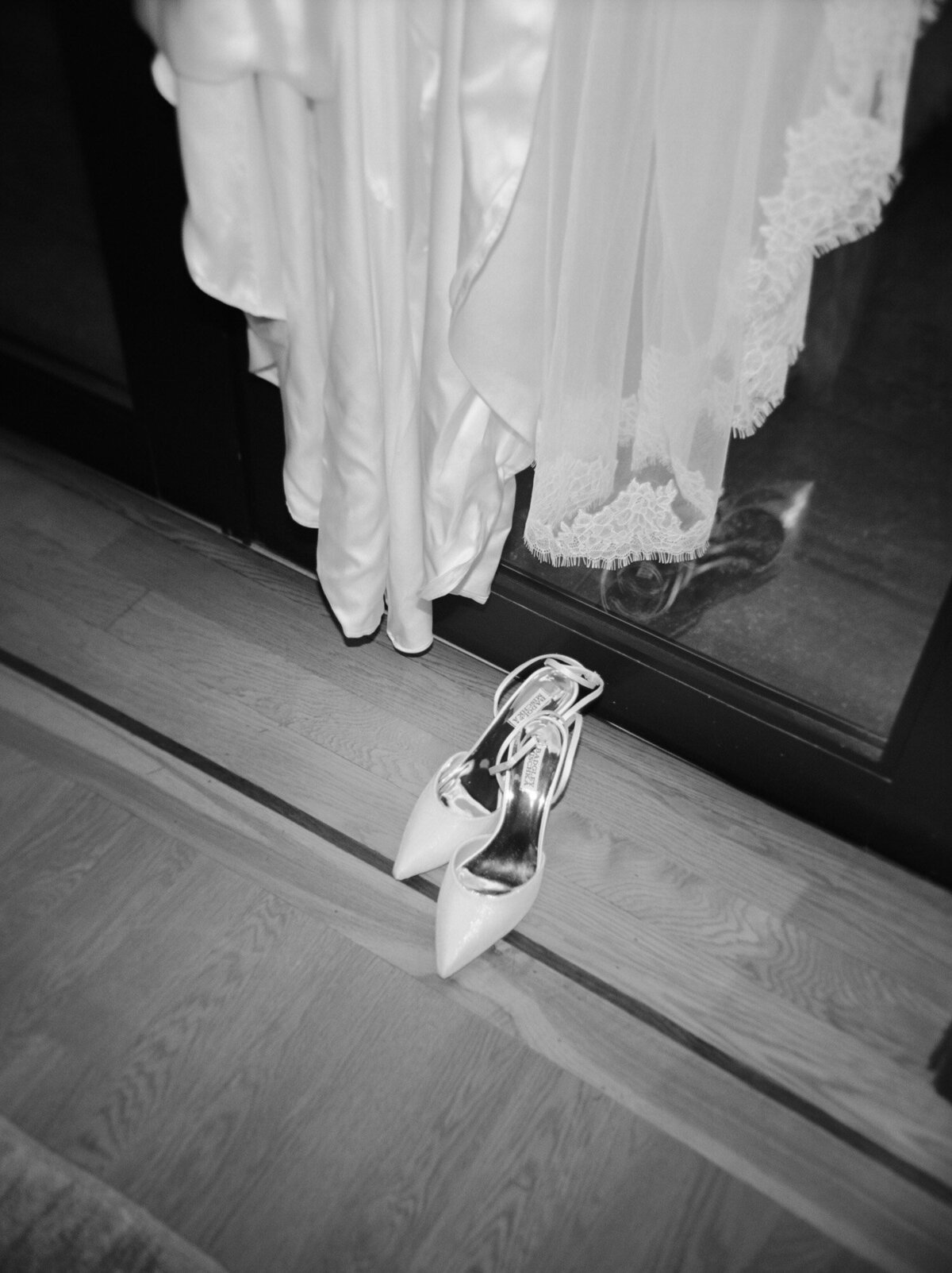 Candid film wedding photography shows wedding dress and shoes at Shinola Hotel, Detroit