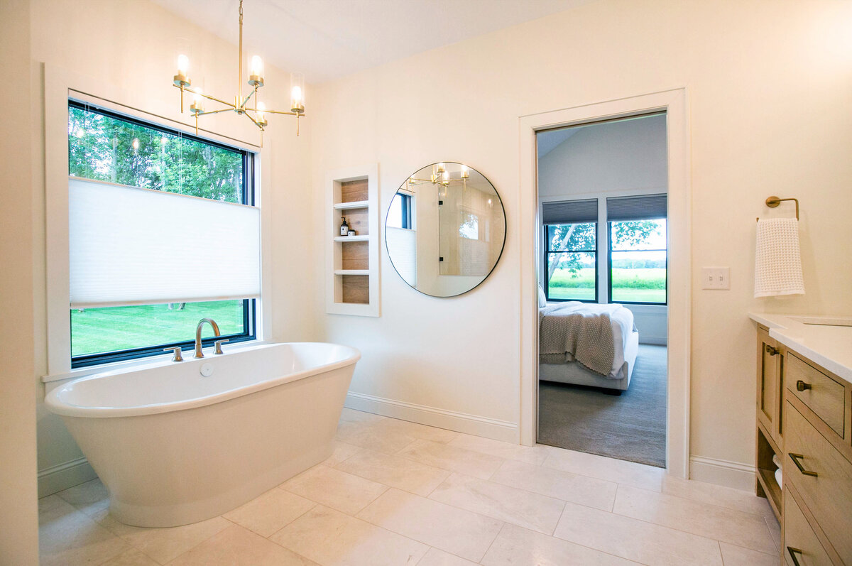 Custom bathroom with soaking tub, double vanity, and walk-in shower in Otsego custom home