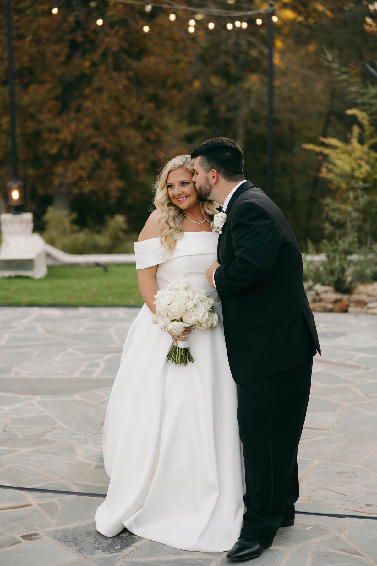 groom kissing brides head