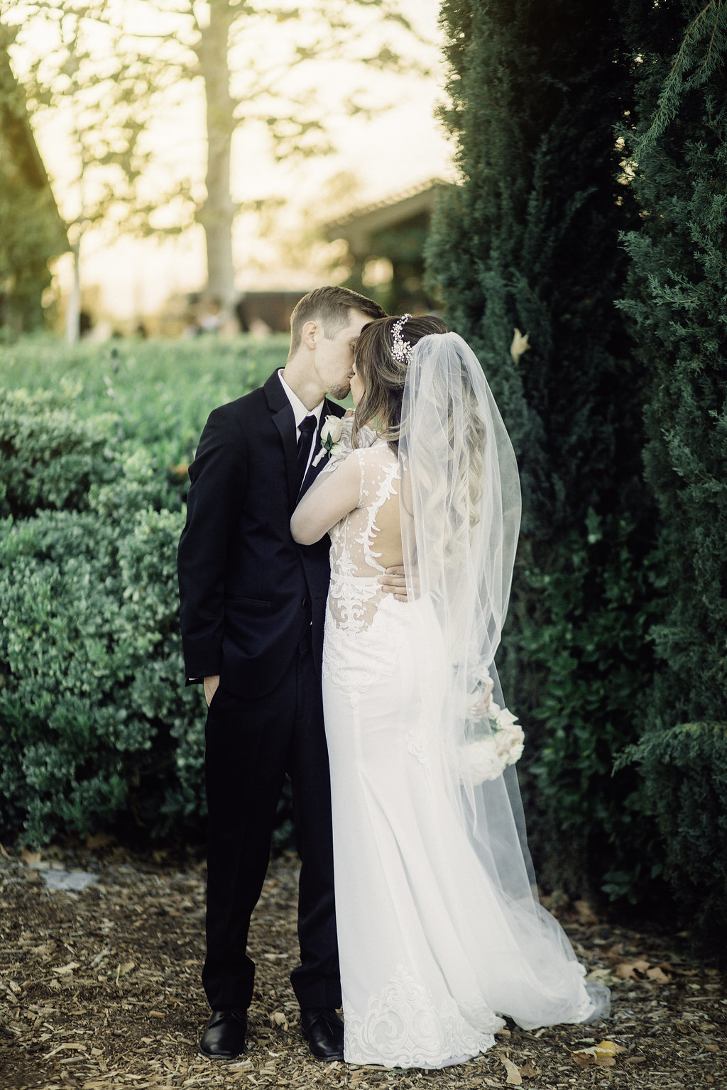 Wedding Photograph Of Bride And Groom  Kissing in The Garden Los Angeles