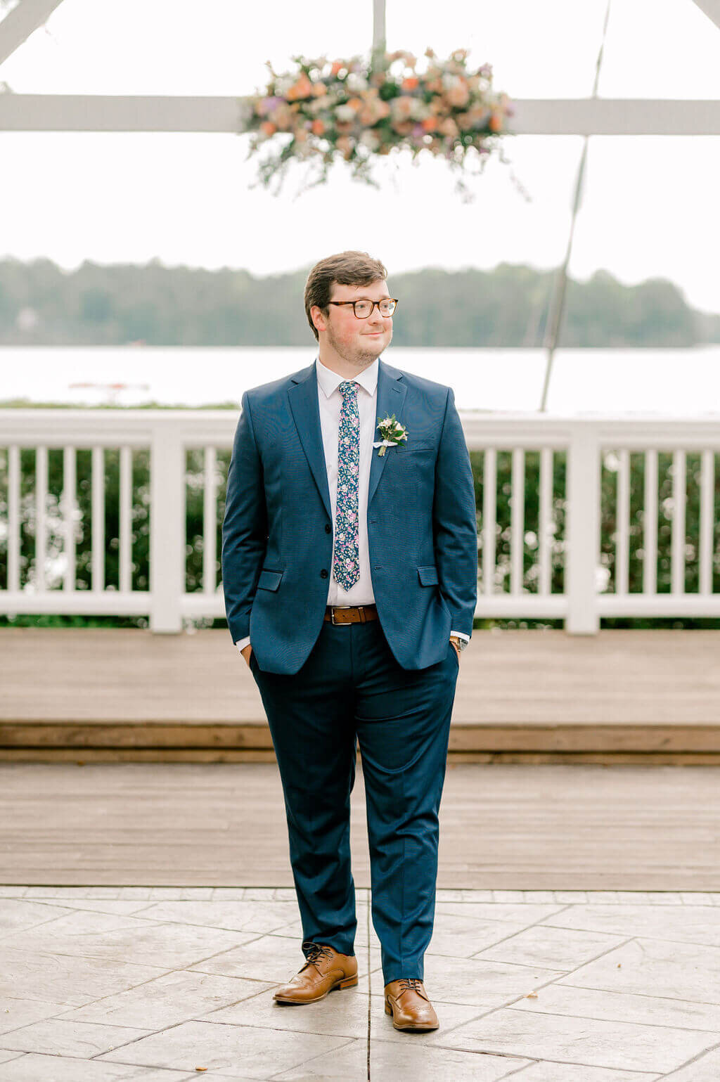 Classic image of the groom standing with hands in his pockets on his wedding day.