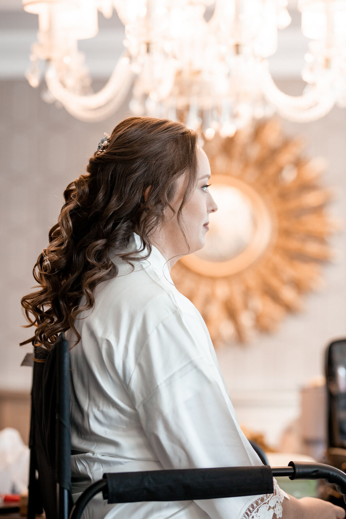 bride sitting waiting to get make up on