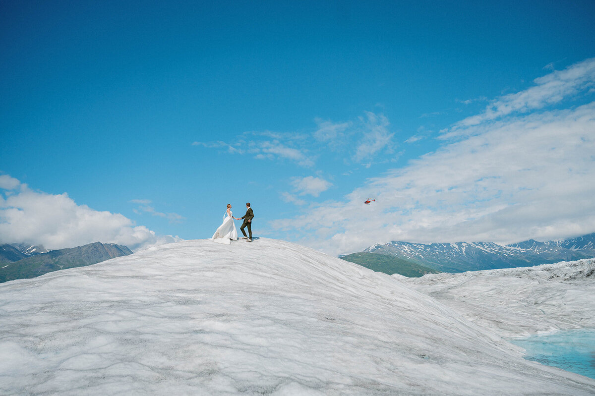couple stand on the glacier