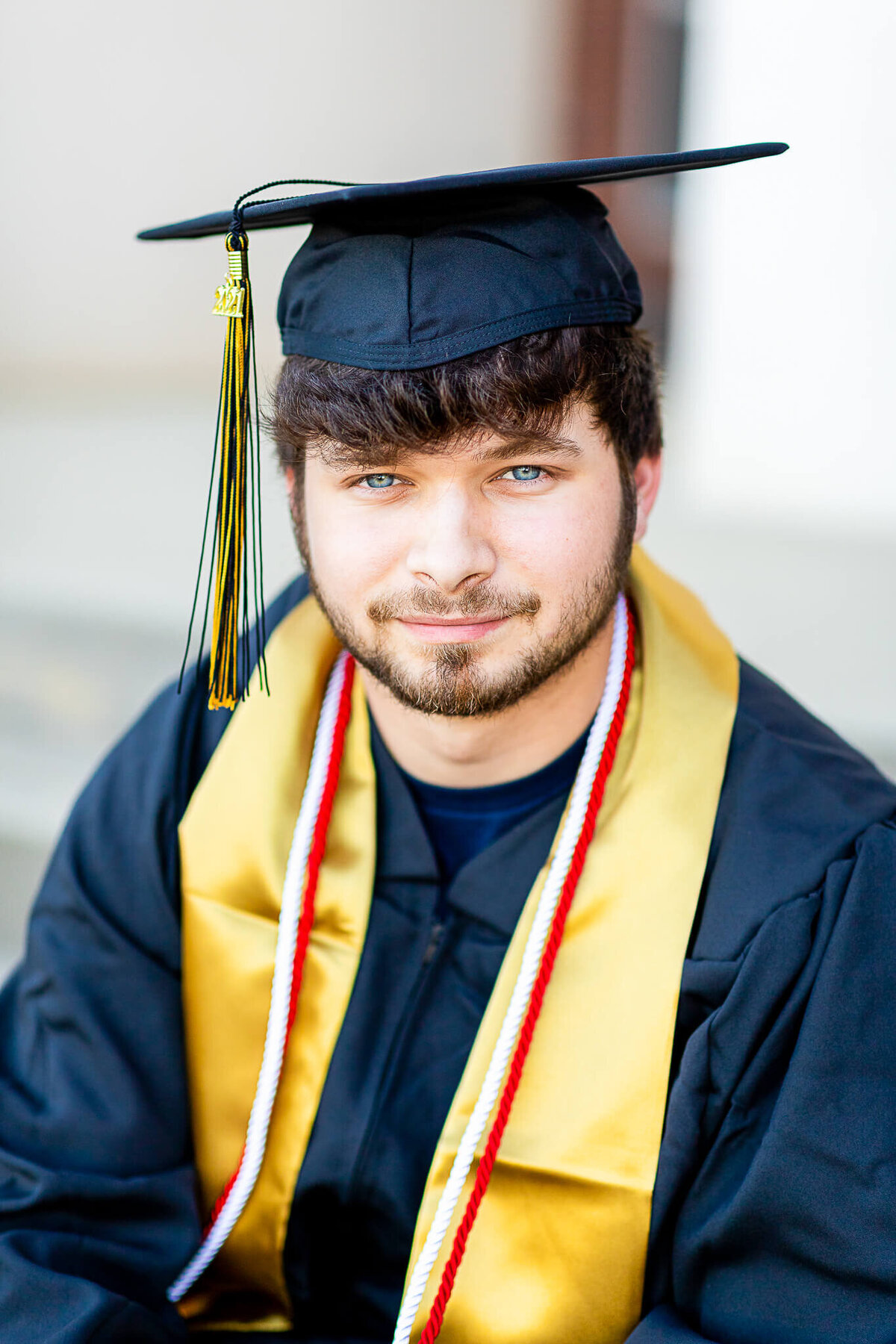 High school senior male in his cap and gown at his high school