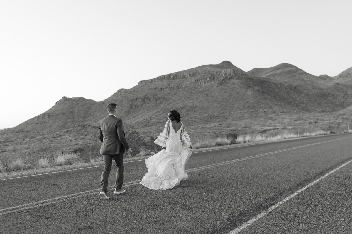couple playfully runs on the road