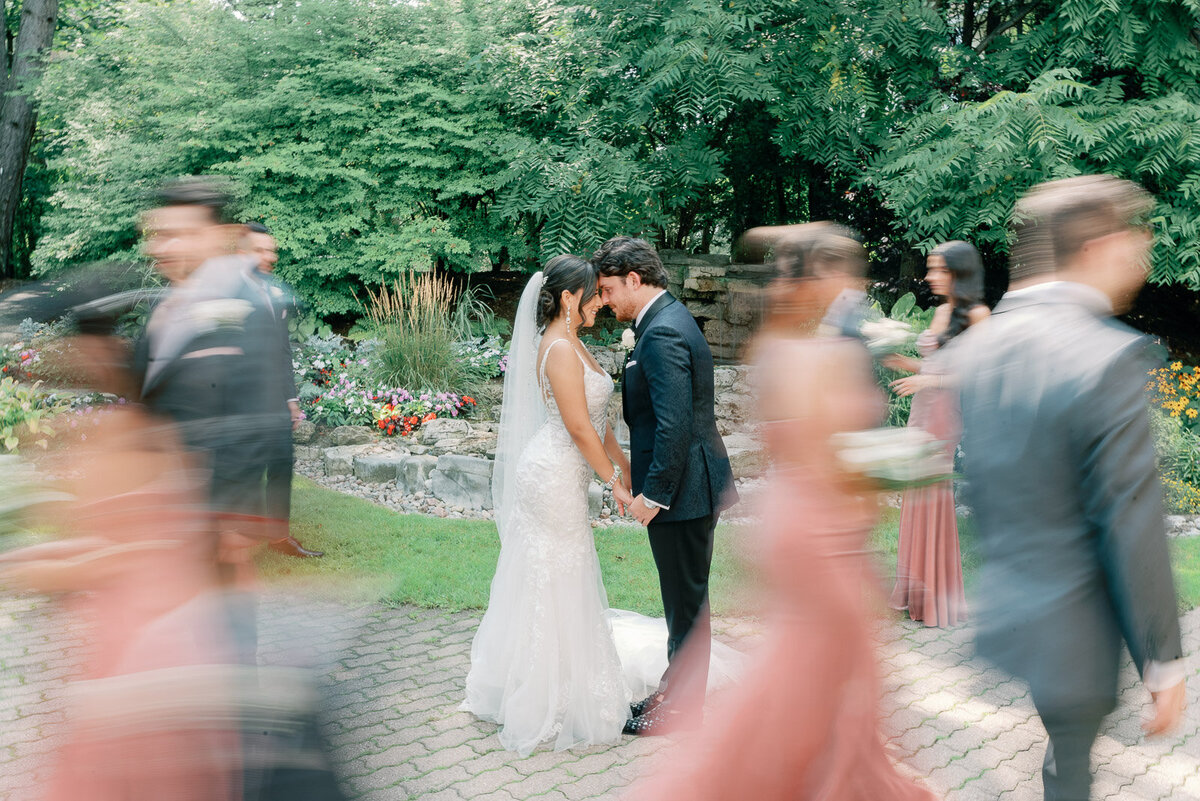 shutter drag of bride and groom intimately standing next to each other on an outdoor dance floor