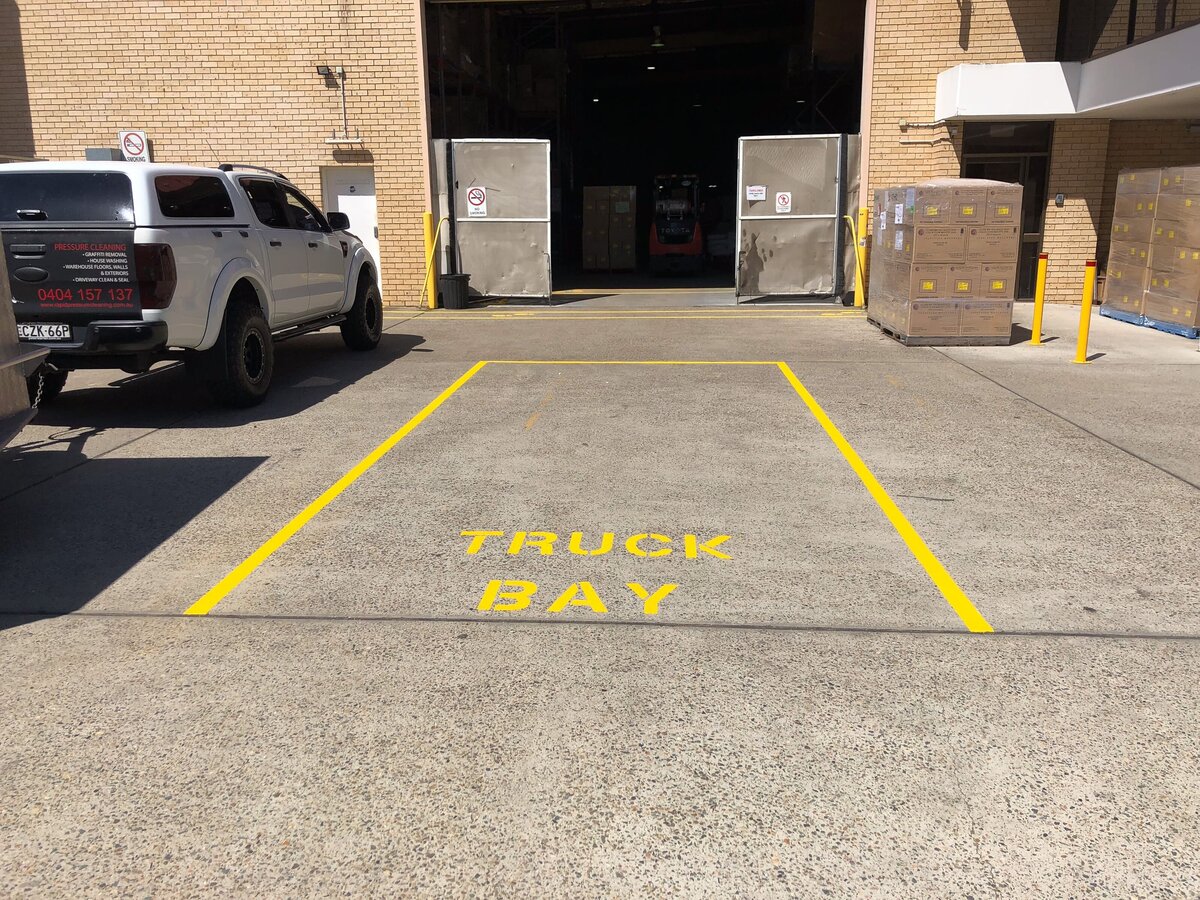 Line marking for a truck bay area  on the outside of a warehouse.
