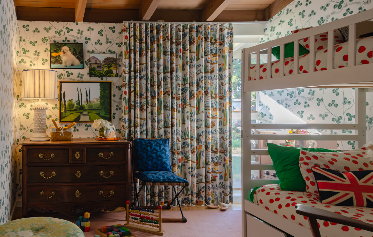 Whimsical child bedroom bold wallpaper and curtains , vintage furnishings and art finds