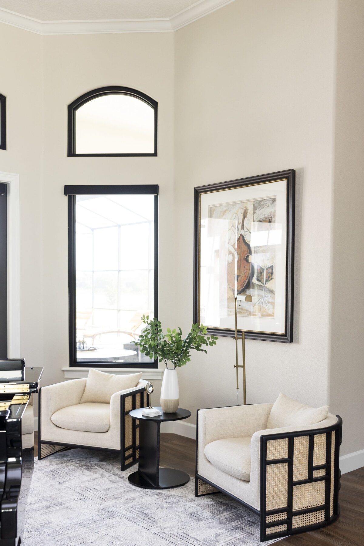 dewine design orlando interior designer windermere full home renovation black trimmed windoes and entrywall chiars and round sidetable